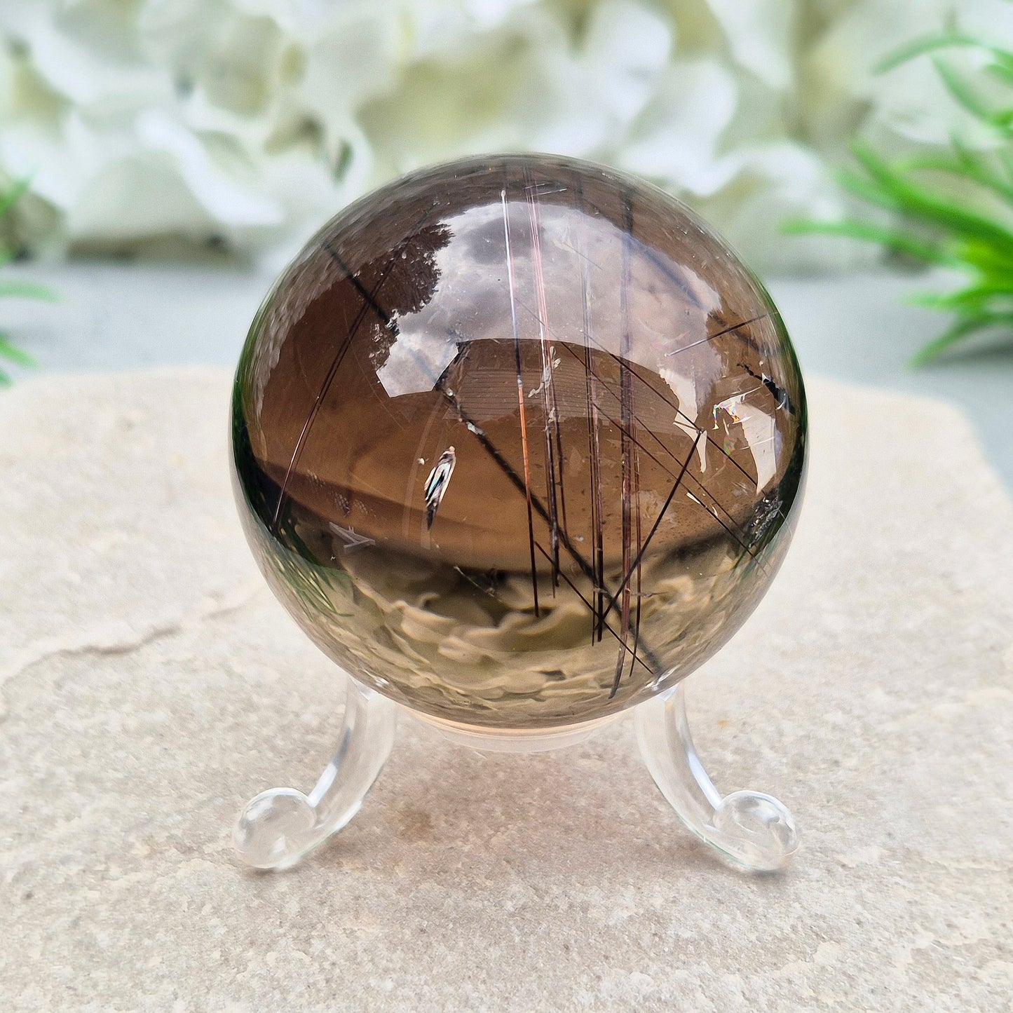 Stunning rare and collectible smoky quartz sphere, with fiery copper red rutile needles inclusions and with a rainbow flash.