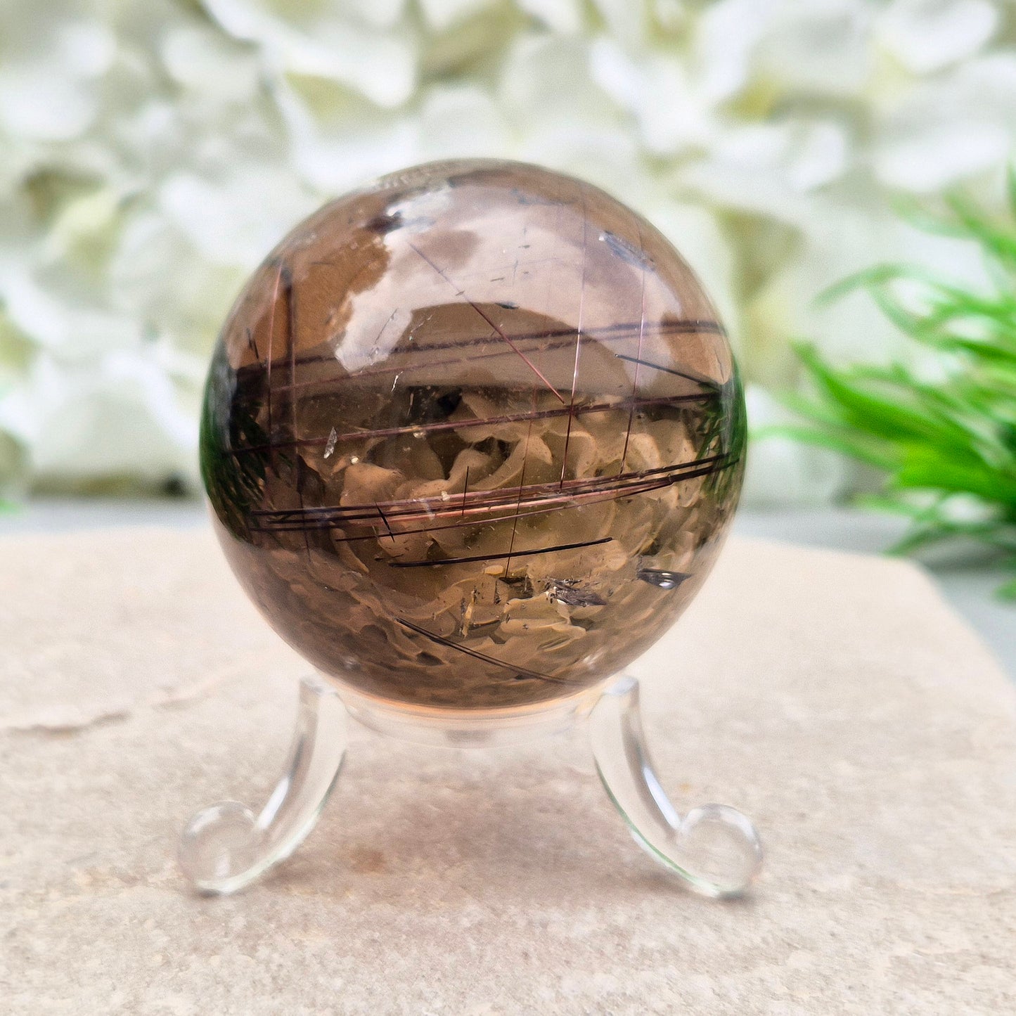 Stunning rare and collectible smoky quartz sphere, with fiery copper red rutile needles inclusions and with a rainbow flash.