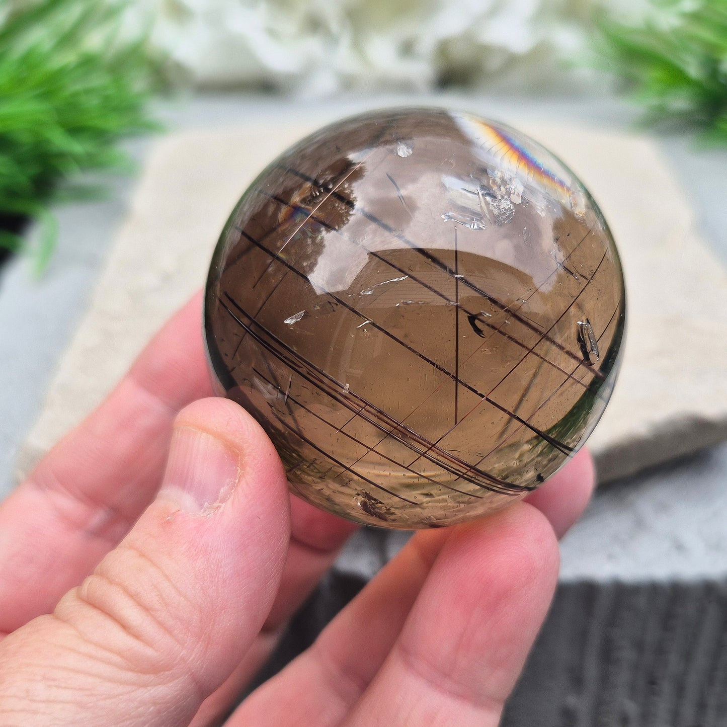 Stunning rare and collectible smoky quartz sphere, with fiery copper red rutile needles inclusions and with a rainbow flash.