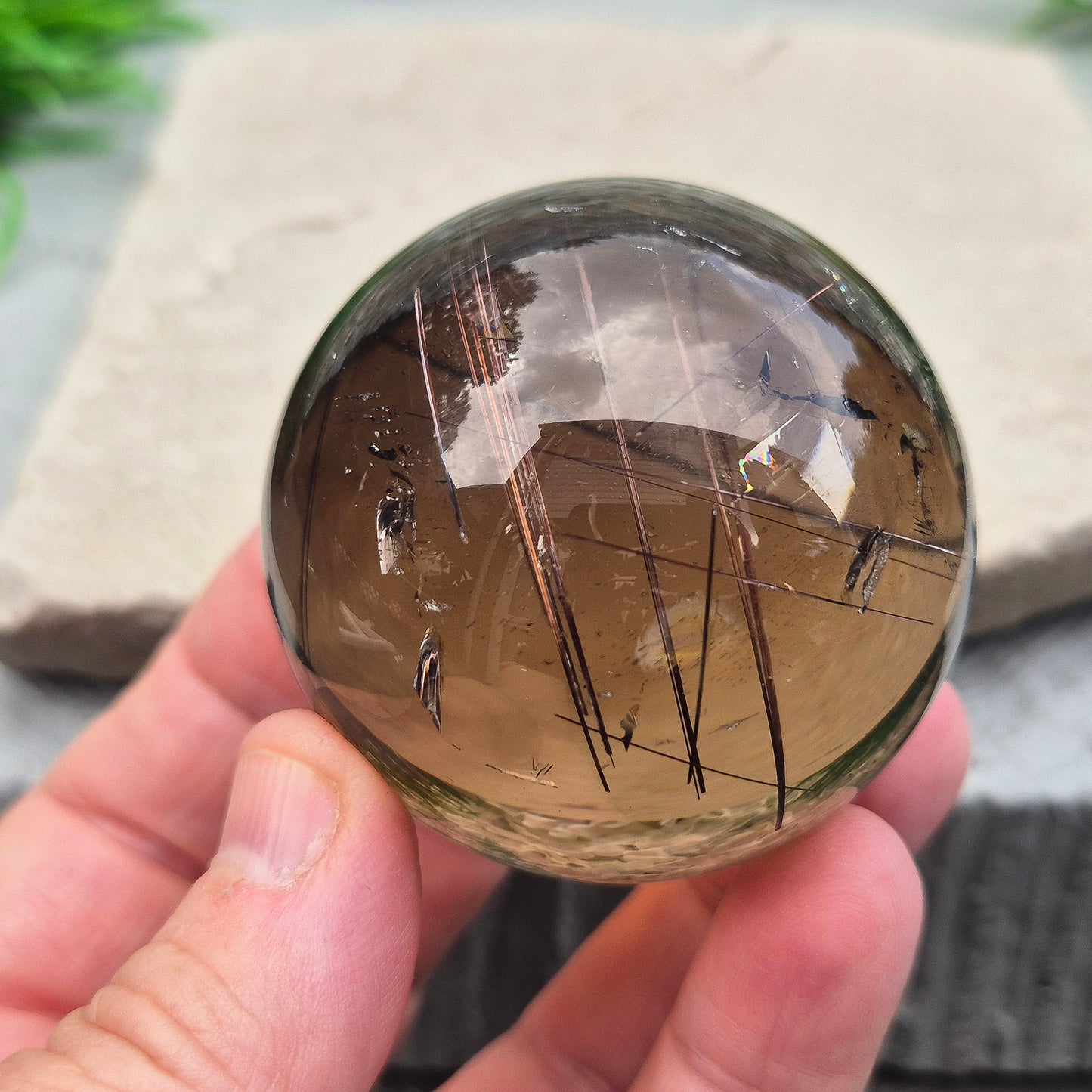 Stunning rare and collectible smoky quartz sphere, with fiery copper red rutile needles inclusions and with a rainbow flash.