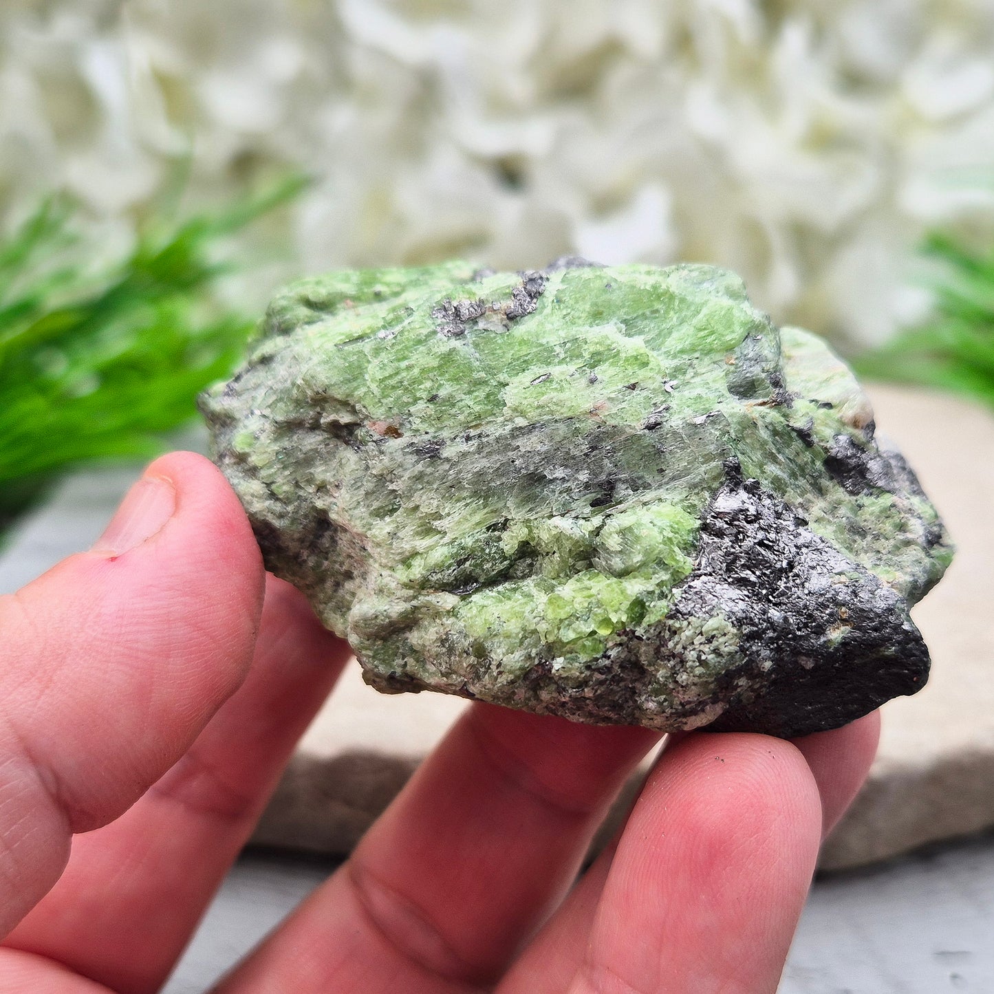 This truly rare natural green tremolite comes straight from the renowned Merelani Hills of Tanzania — the same region that gave us Tanzanite. It’s a stone of gentle energetic awakening, with soft green blades of tremolite.
