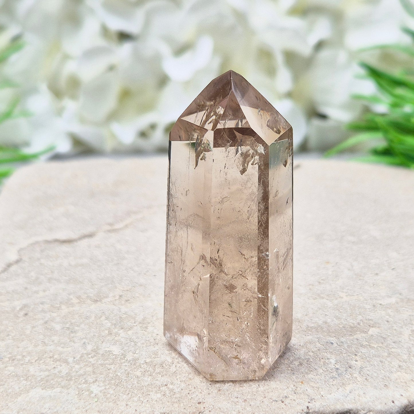 This polished Smoky Quartz point from Brazil features a light brown tone with subtle, light-reflecting inclusions. It’s not heat-treated — this is genuine, naturally formed Smoky Quartz.