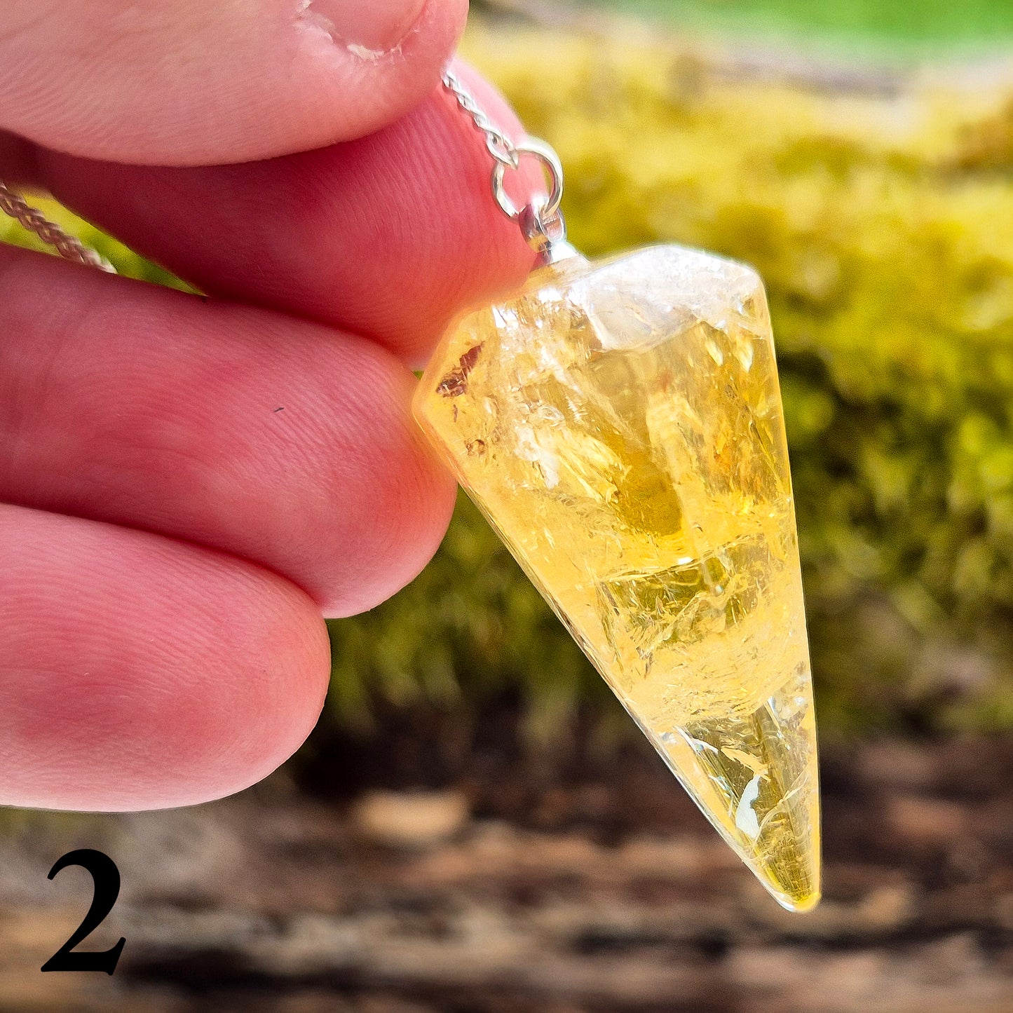 Citrine Crystal Pendulum from Brazil. These stunning sunny pendulums carry the warm, golden glow Citrine is loved for. Each has a yellow bead at the end of the chain making it comfortable to hold and easy to use.