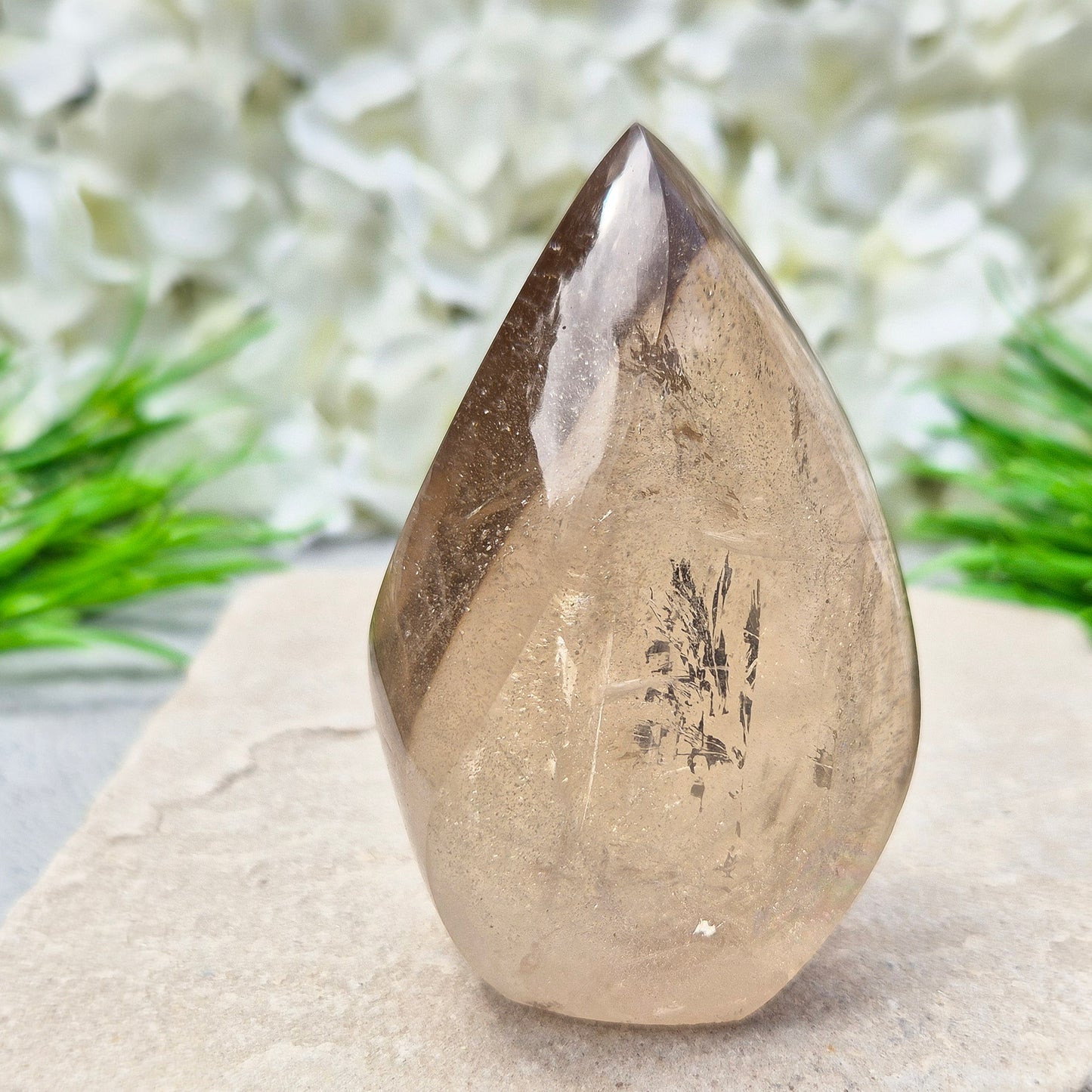 This polished Smoky Quartz Crystal Flame from Brazil features a light brown tone with subtle, light-reflecting inclusions and an amazing rainbow. It’s not heat-treated — this is genuine, naturally formed Smoky Quartz.