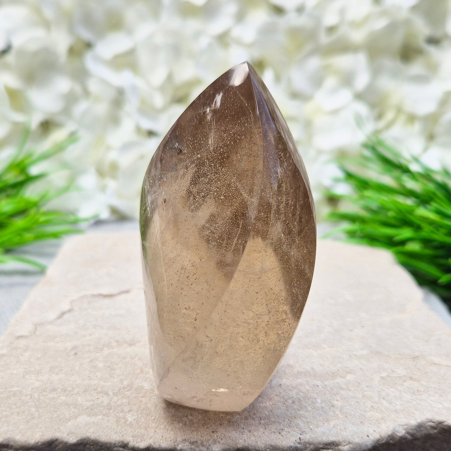 This polished Smoky Quartz Crystal Flame from Brazil features a light brown tone with subtle, light-reflecting inclusions and an amazing rainbow. It’s not heat-treated — this is genuine, naturally formed Smoky Quartz.
