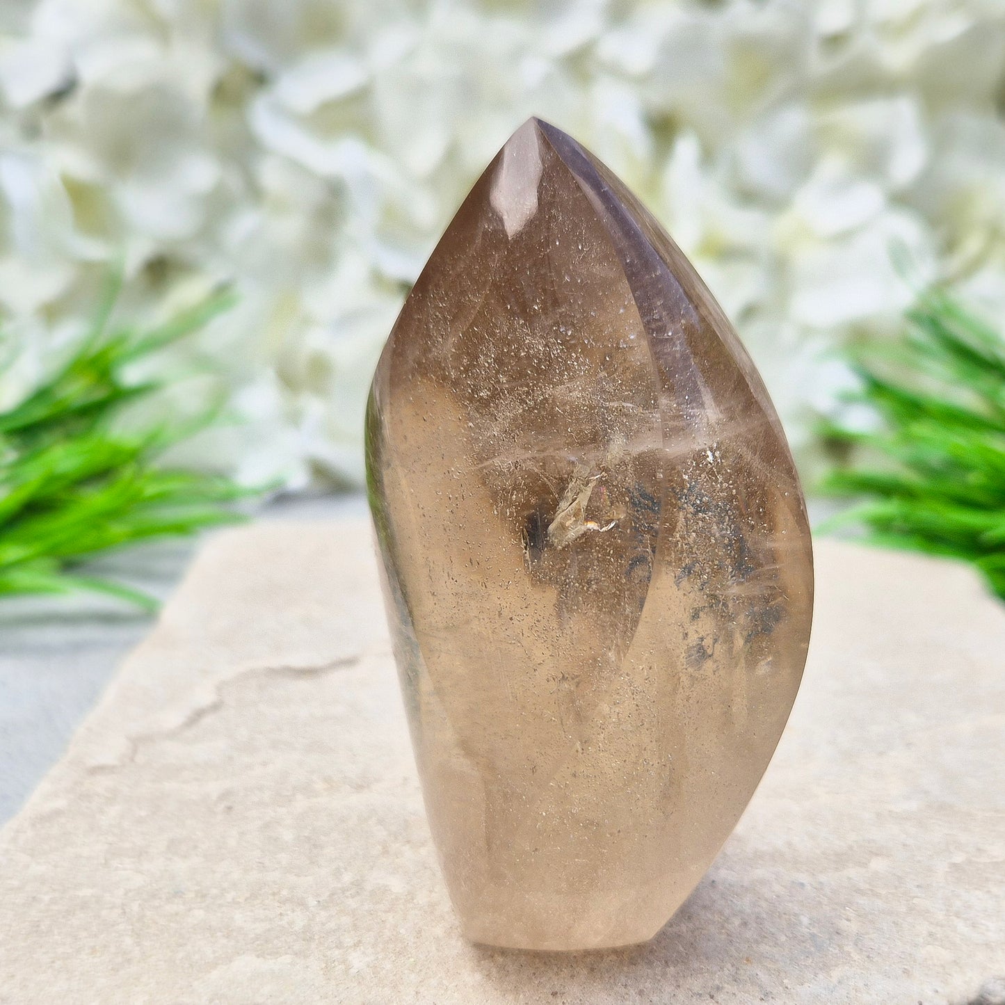 This polished Smoky Quartz Crystal Flame from Brazil features a light brown tone with subtle, light-reflecting inclusions and an amazing rainbow. It’s not heat-treated — this is genuine, naturally formed Smoky Quartz.