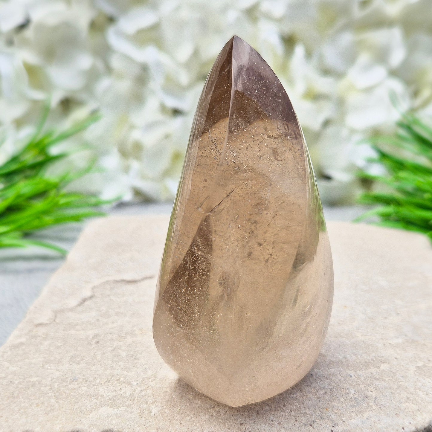 This polished Smoky Quartz Crystal Flame from Brazil features a light brown tone with subtle, light-reflecting inclusions and an amazing rainbow. It’s not heat-treated — this is genuine, naturally formed Smoky Quartz.