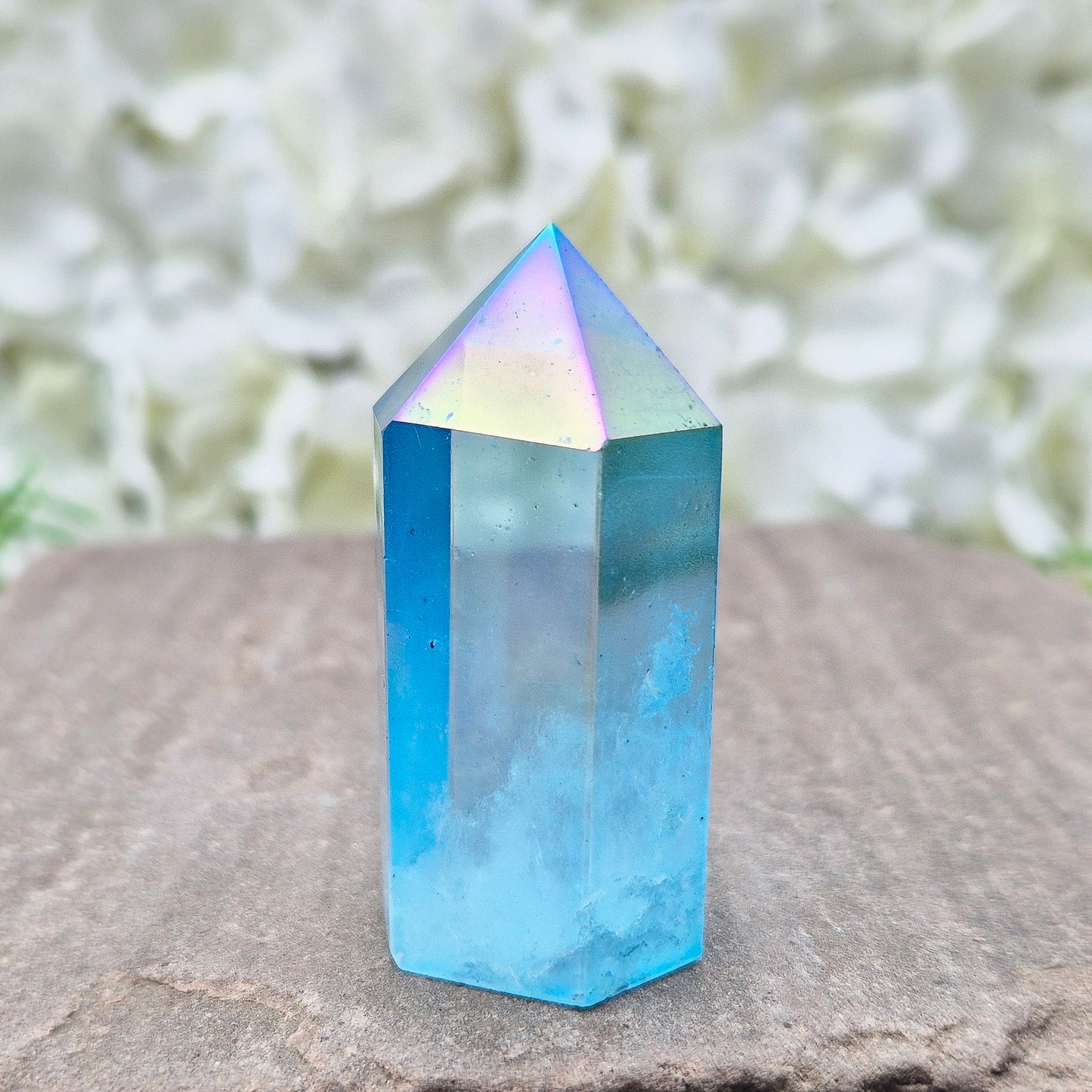 This beautiful Aqua Aura Quartz Standing Point from Brazil has an electric blue sheen with soft rainbow flashes, created by bonding pure gold to Quartz in a special heat process. The result is a striking crystal with a bright, peaceful energy.