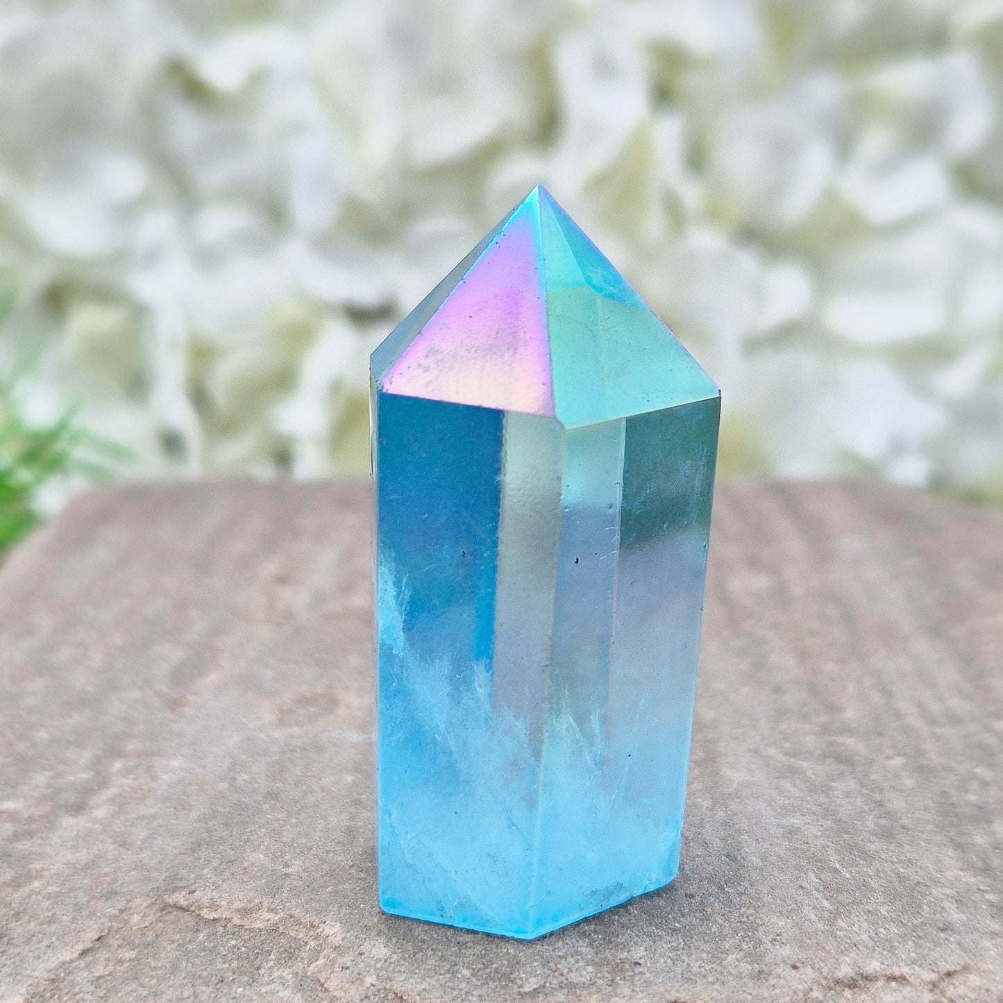 This beautiful Aqua Aura Quartz Standing Point from Brazil has an electric blue sheen with soft rainbow flashes, created by bonding pure gold to Quartz in a special heat process. The result is a striking crystal with a bright, peaceful energy.