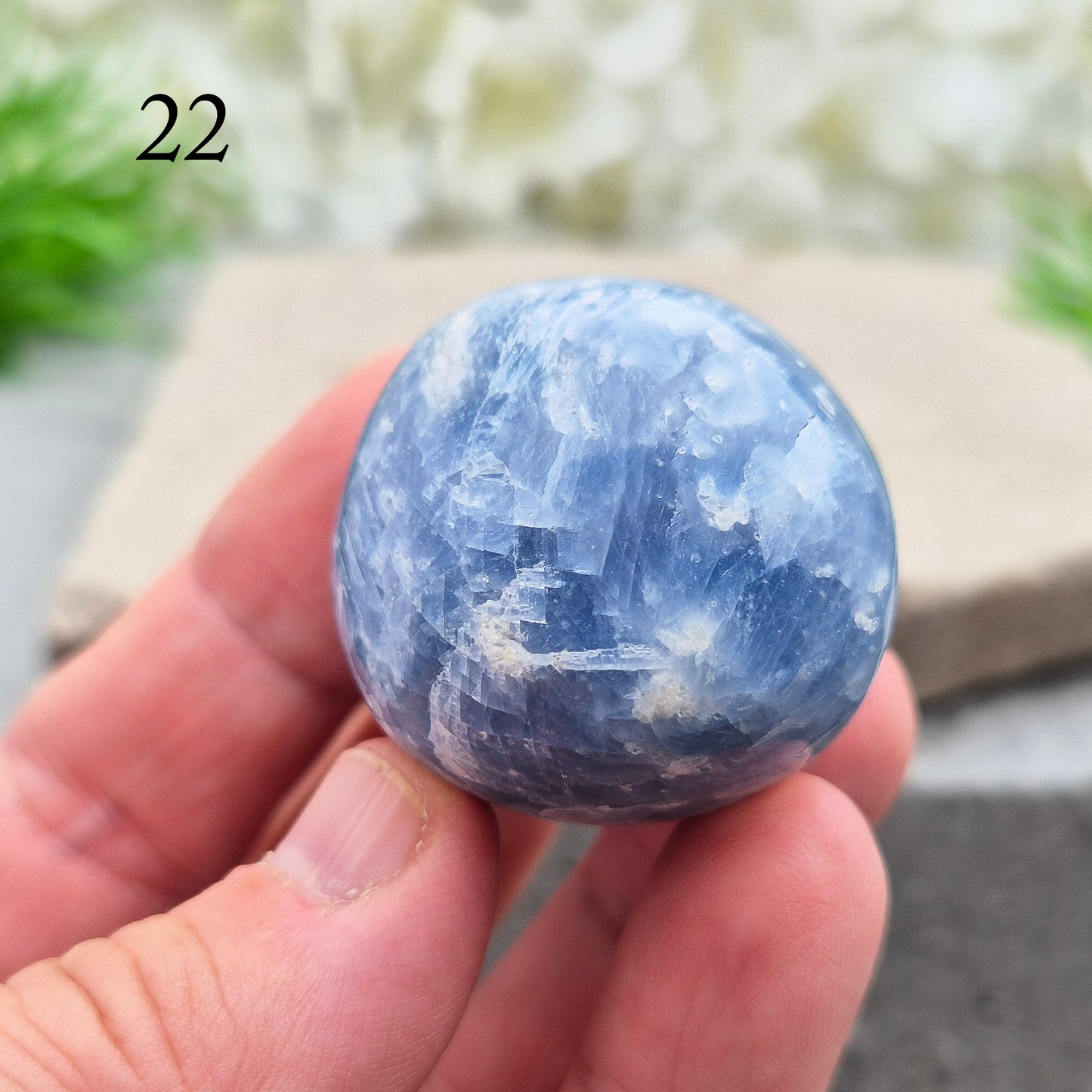 This polished Blue Calcite crystal from Madagascar has a lovely blue colouring and a rounded, gently domed shape that fits naturally into the palm. It carries a comforting, wave-like energy — peaceful, steady, and easy to be around.