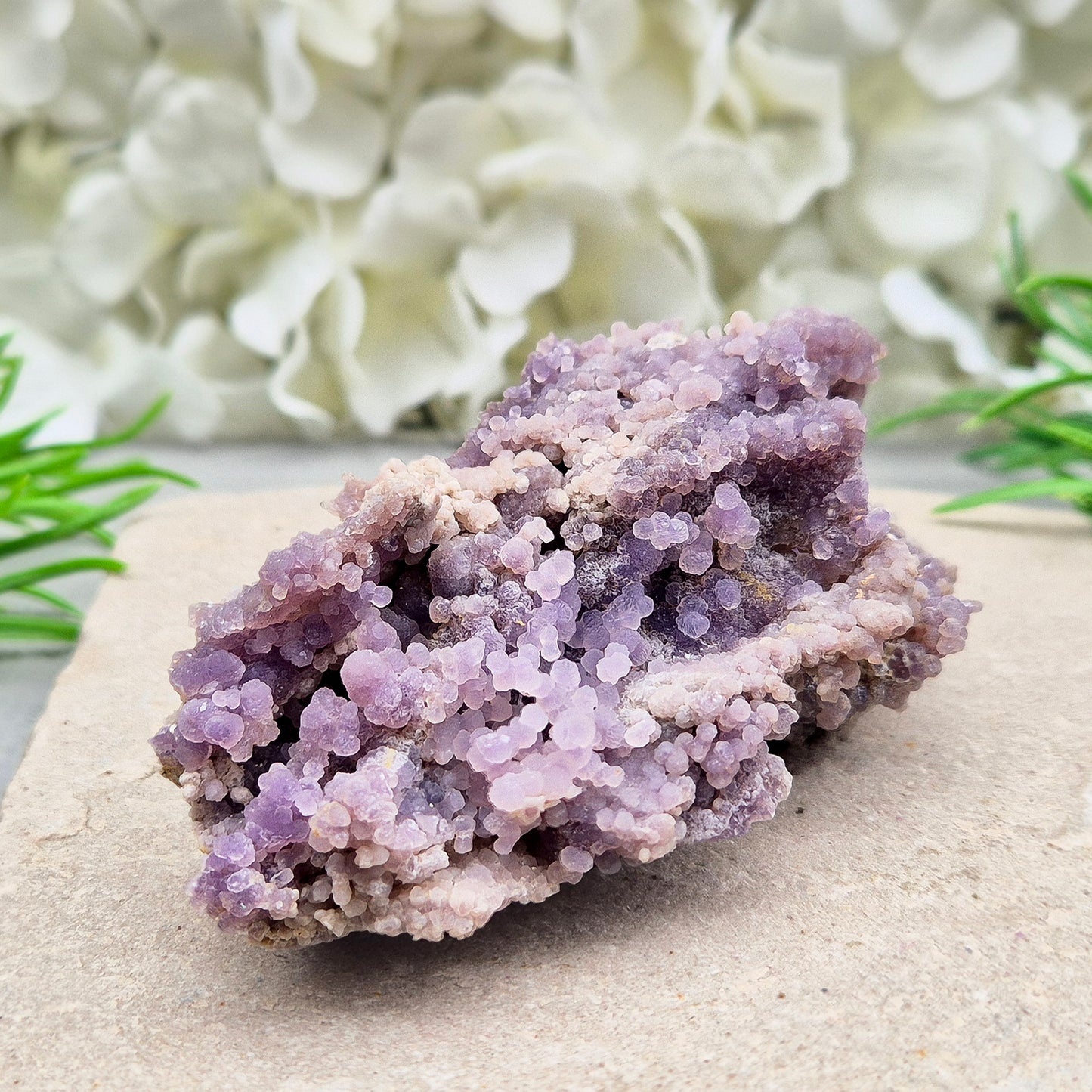 This beautiful Grape Agate cluster (also known as Purple Chalcedony or Botryoidal Purple Chalcedony) comes from Indonesia. Its natural ‘grape-like’ formations are made up of tiny rounded crystals that have grown closely together.