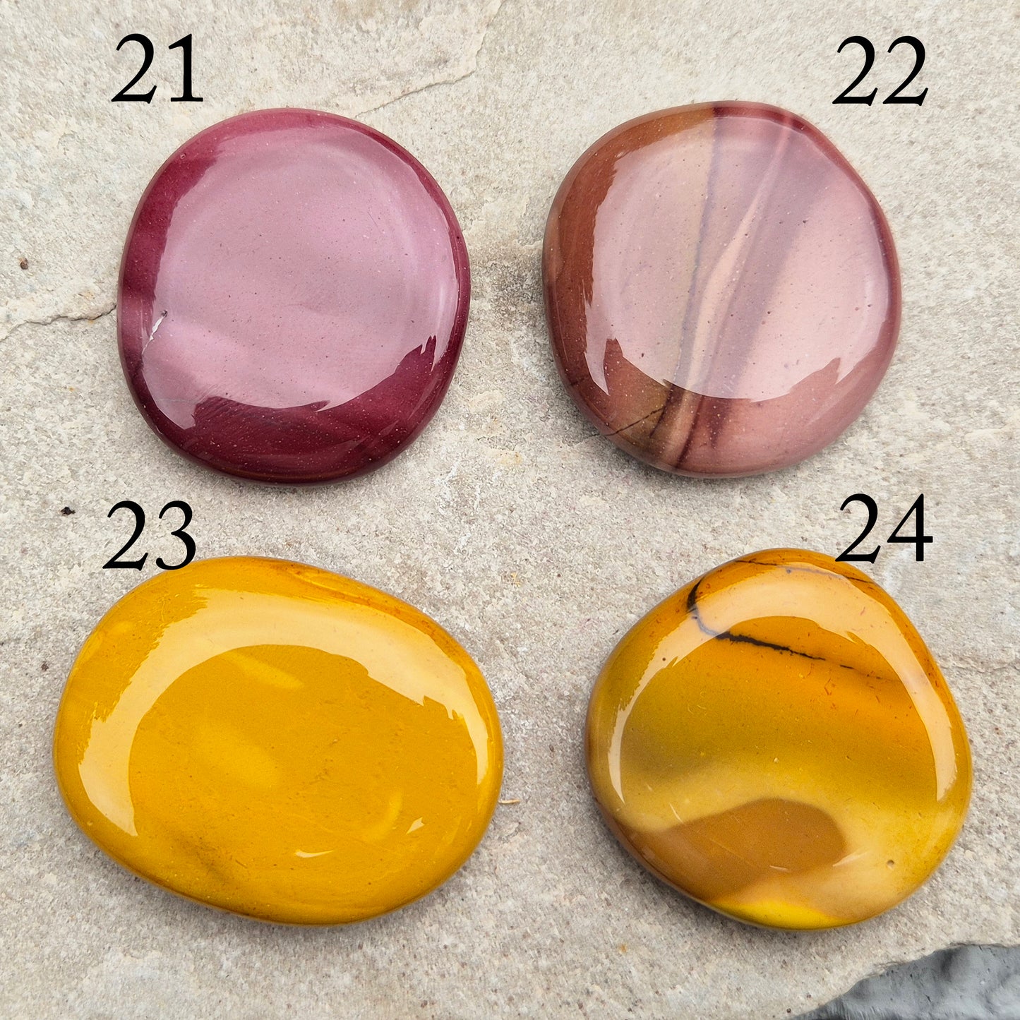 Mookaite Crystal Palm Stone. From the Mooka Creek region in Western Australia, each Mookaite palm stone displays a unique mix of earthy tones—reds, yellows, creams, and purples.