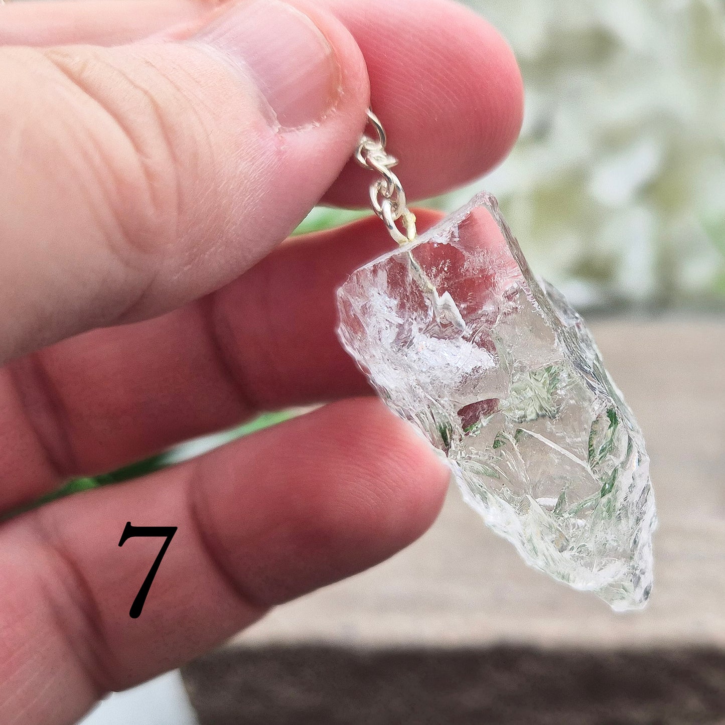 This Rock Quartz Crystal Pendulum from Brazil features a natural quartz crystal and a white bead at the end of the chain.