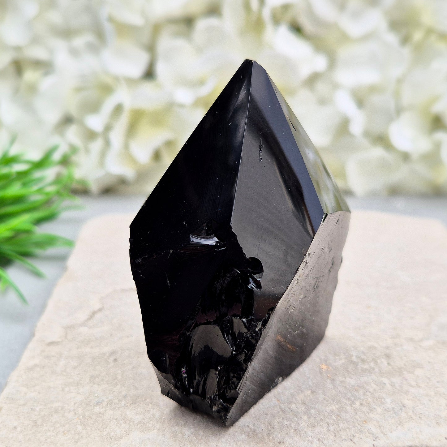 This Black Obsidian standing point comes from Mexico, point is shaped into a six-sided tip with natural sides and a cut base.