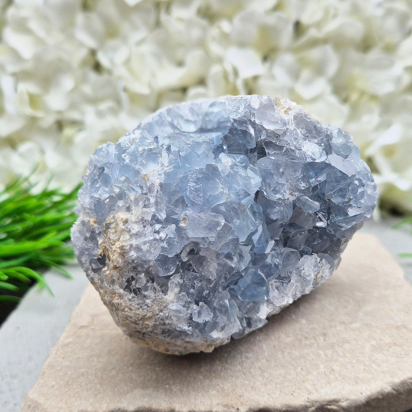 Celestite Crystal Cluster from Madagascar. This beautiful cluster shows sparkling sky-blue crystals on a natural matrix. The base is softly rounded but still sits well on a flat surface.