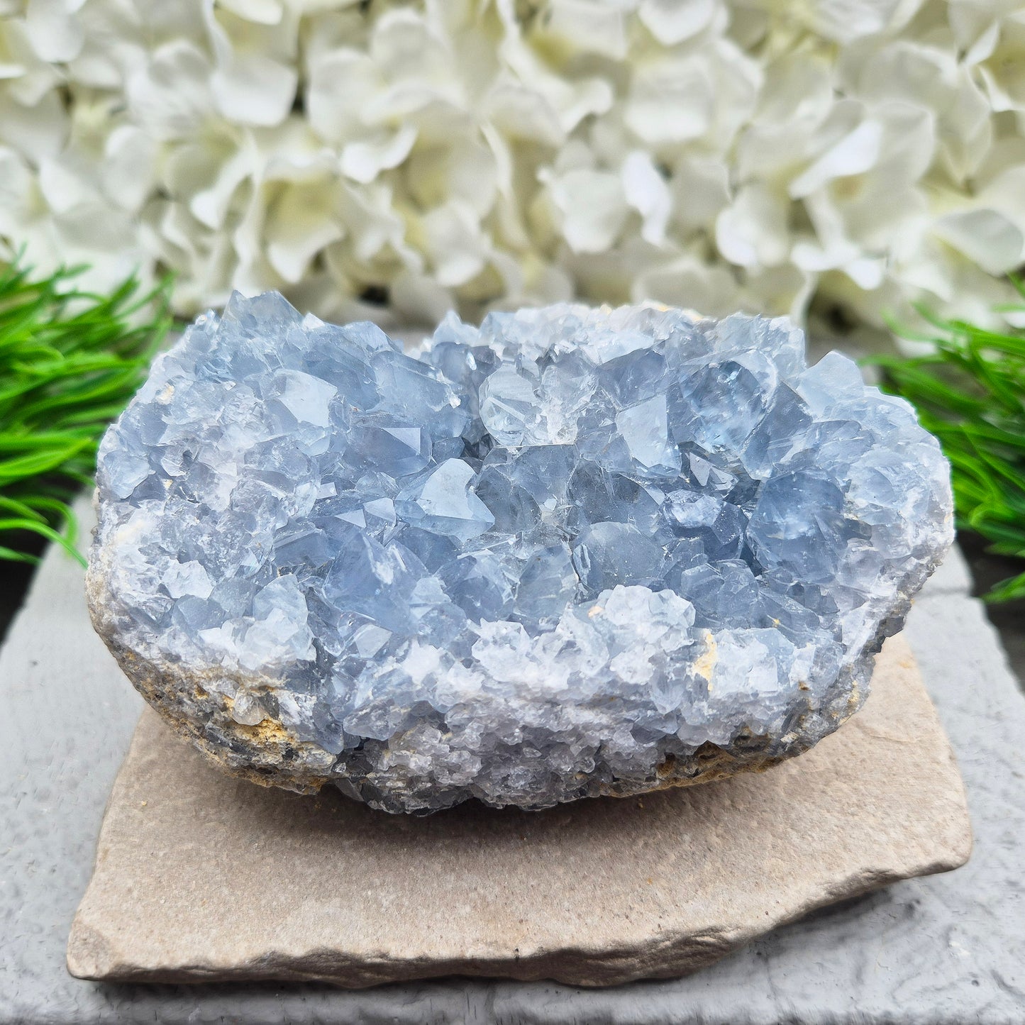 Celestite Crystal Cluster from Madagascar. This beautiful cluster shows sparkling sky-blue crystals on a natural matrix. The base is softly rounded but still sits well on a flat surface.