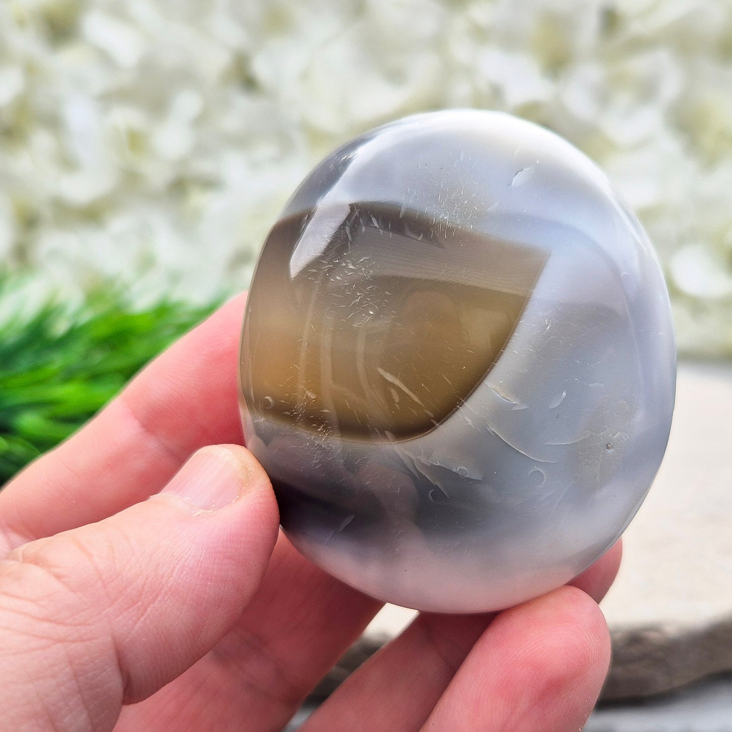 Orca Agate Crystal Pebble. This beautiful Orca Agate crystal, also known as Grey Agate, comes from Madagascar and is named after the Orca whale. It has striking brown/grey and white patterning and colouring.