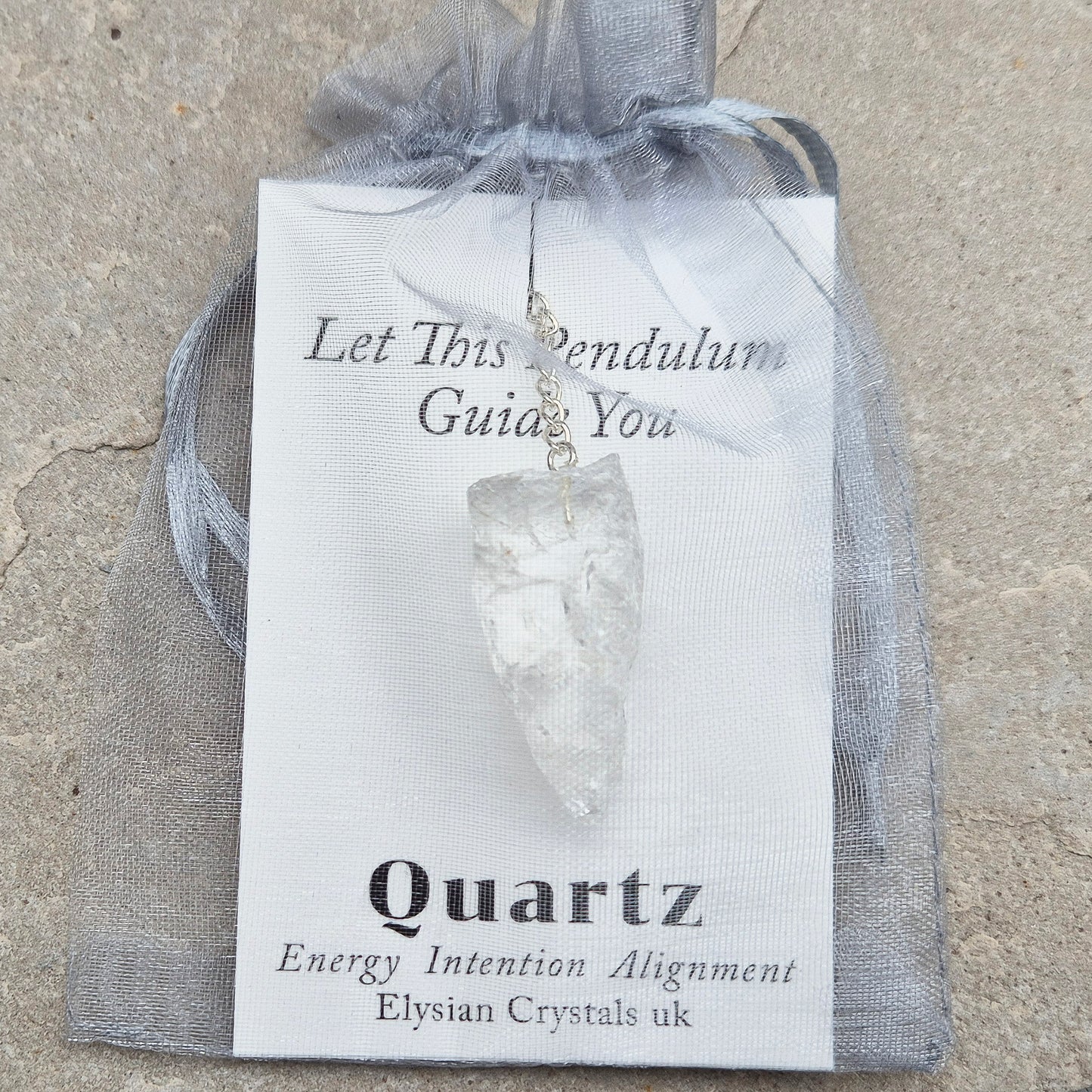 This Rock Quartz Crystal Pendulum from Brazil features a natural quartz crystal and a white bead at the end of the chain. It will come with a card and pouch for safe keeping.