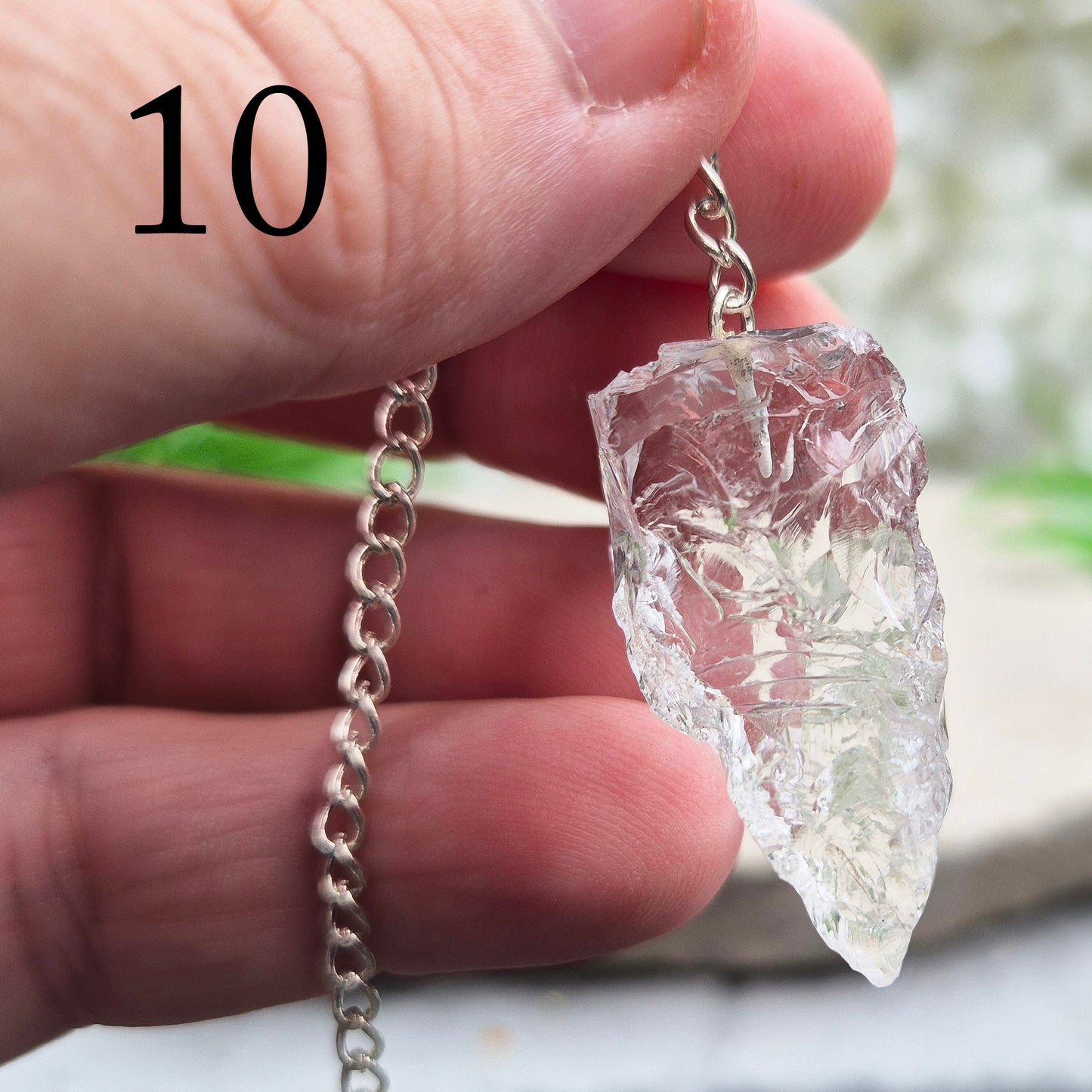 This Rock Quartz Crystal Pendulum from Brazil features a natural quartz crystal and a white bead at the end of the chain. It will come with a card and pouch for safe keeping.