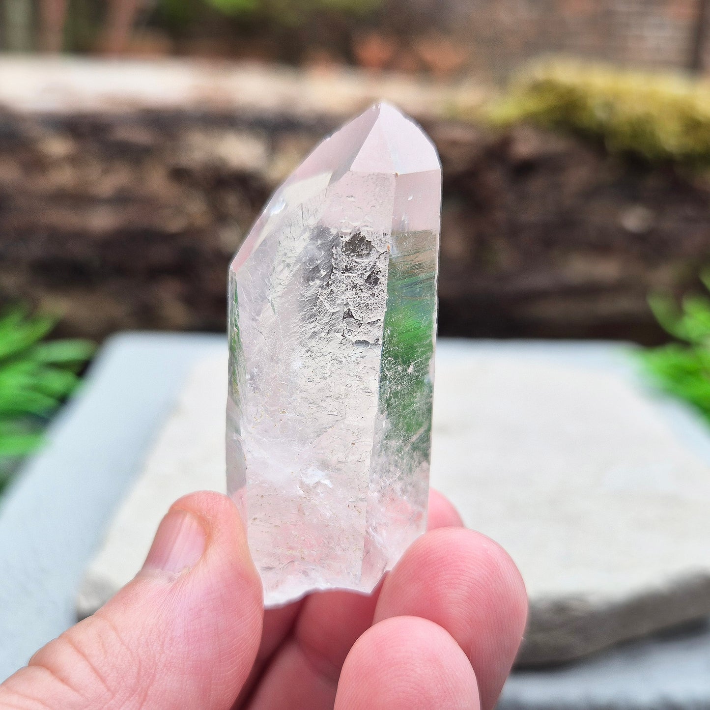 This natural quartz point has lovely clarity with Starbrary markings on at least two sides. These etched shapes — triangles, lines, and patterns — look like ancient writing and are thought to carry cosmic knowledge.