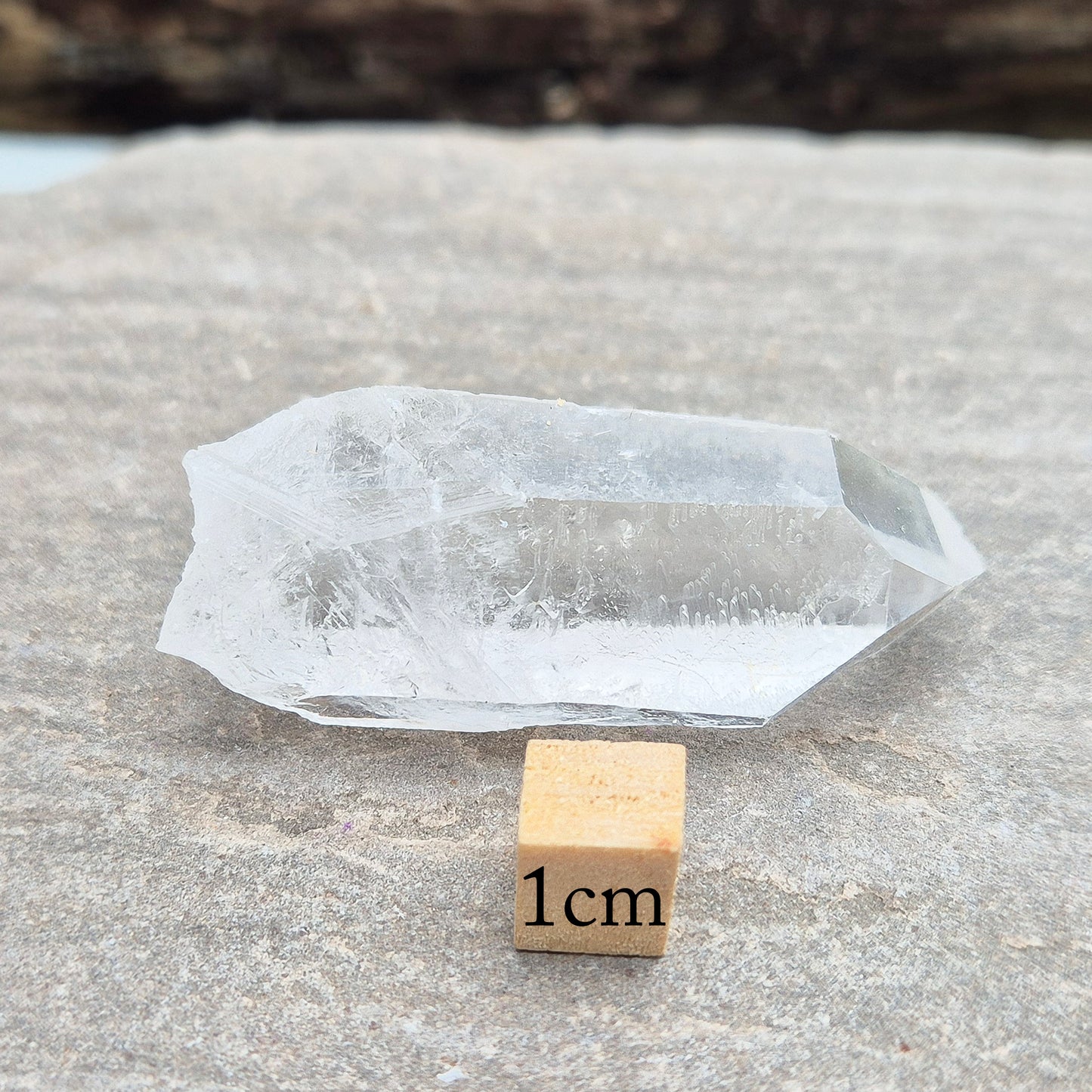 This natural quartz point has lovely clarity with Starbrary markings on at least two sides. These etched shapes — triangles, lines, and patterns — look like ancient writing and are thought to carry cosmic knowledge.