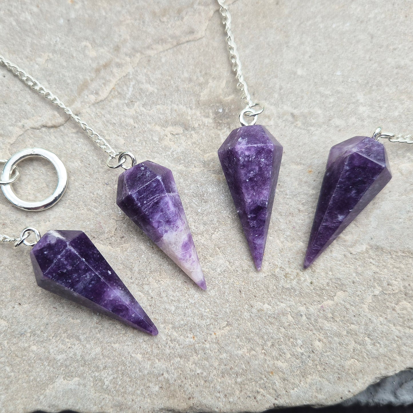 This Lepidolite Crystal Pendulum shows off beautiful deep purple colouring. Lepidolite is valued for its soothing, balancing energy – a gentle aid when working through stress, change, or emotional shifts.