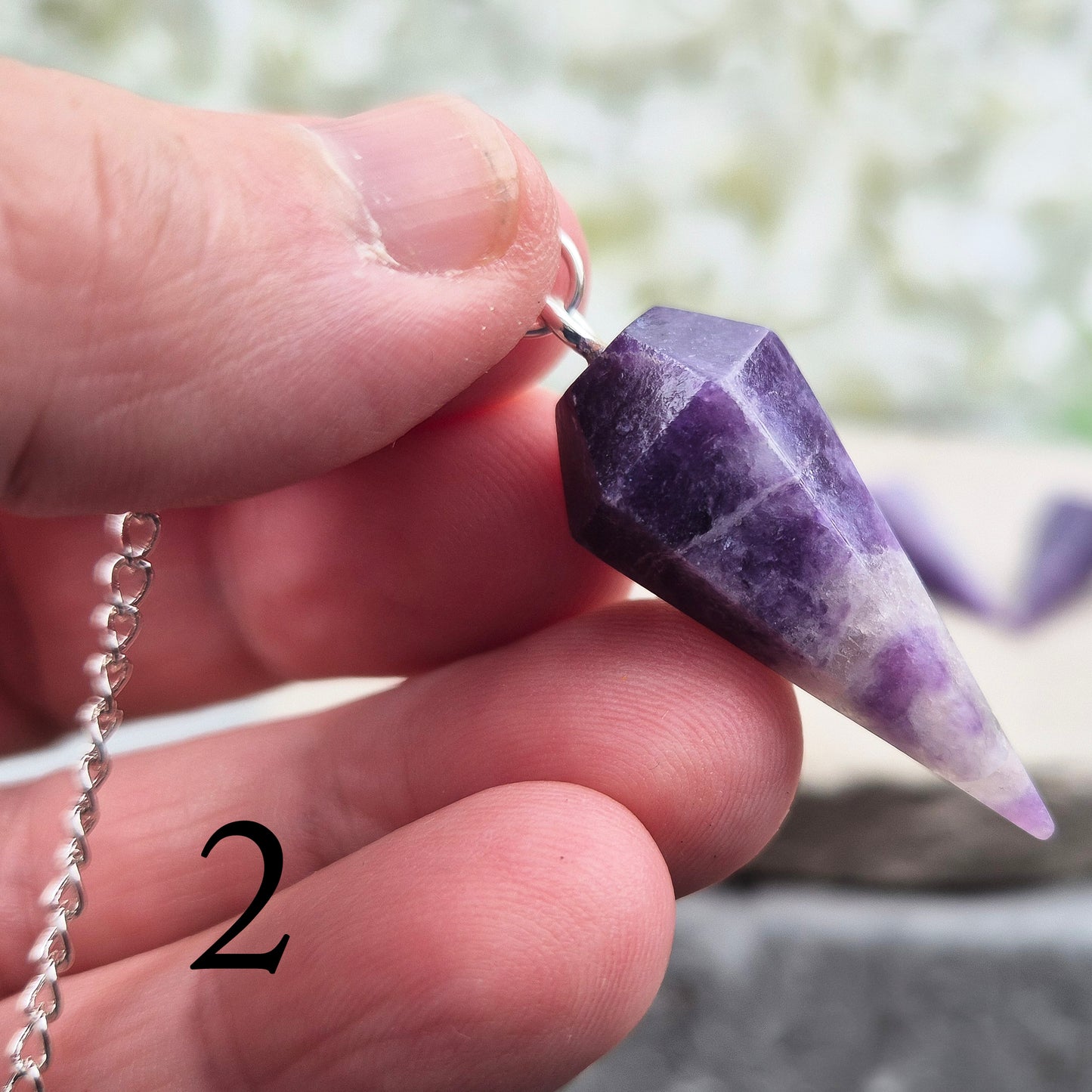 This Lepidolite Crystal Pendulum shows off beautiful deep purple colouring. Lepidolite is valued for its soothing, balancing energy – a gentle aid when working through stress, change, or emotional shifts.