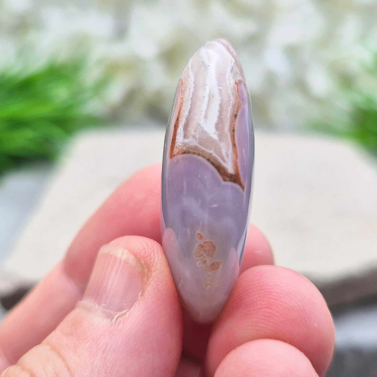 This Moroccan Agate palm stone has been polished and shaped to fit comfortably in the hand, making it perfect for daily use.