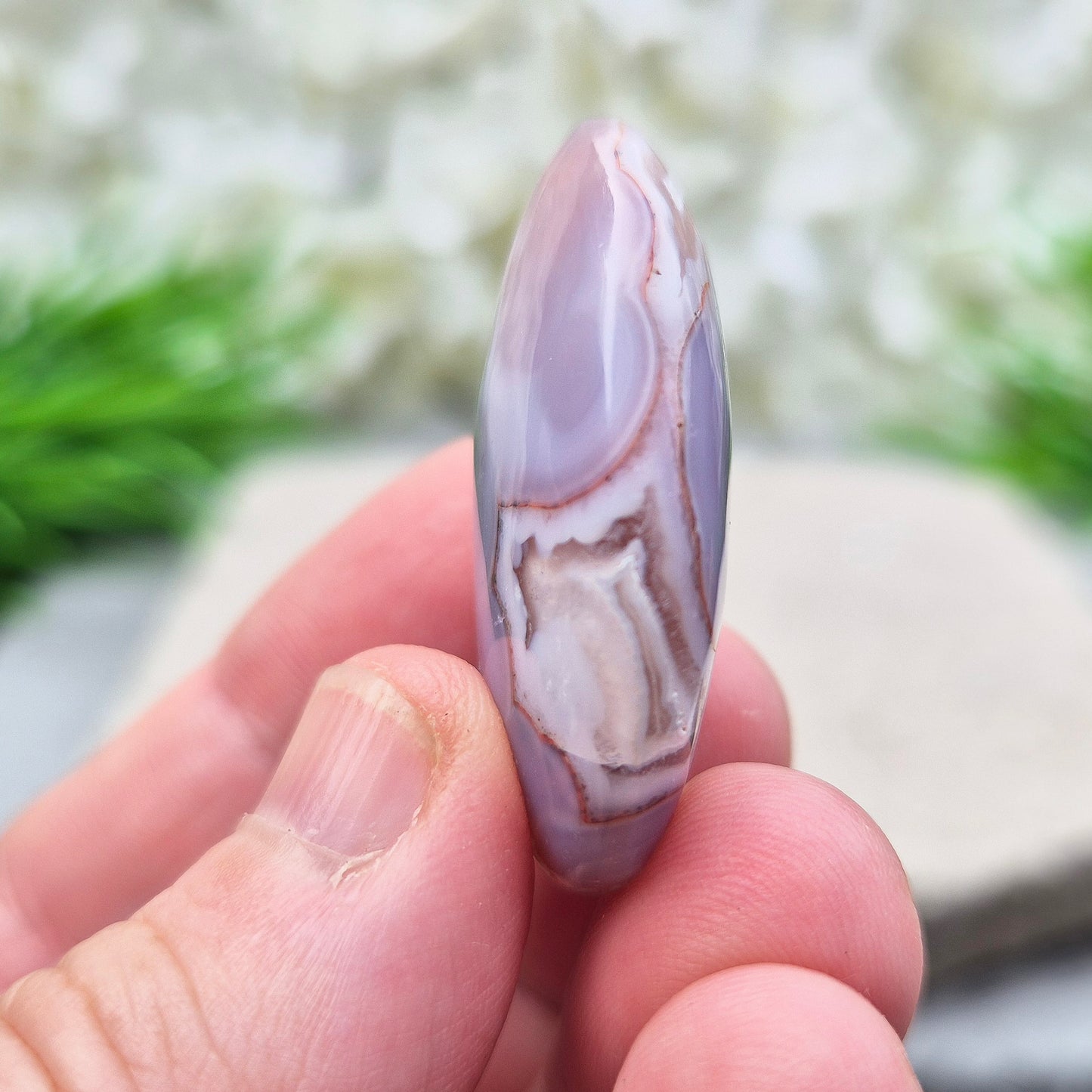 This Moroccan Agate palm stone has been polished and shaped to fit comfortably in the hand, making it perfect for daily use.