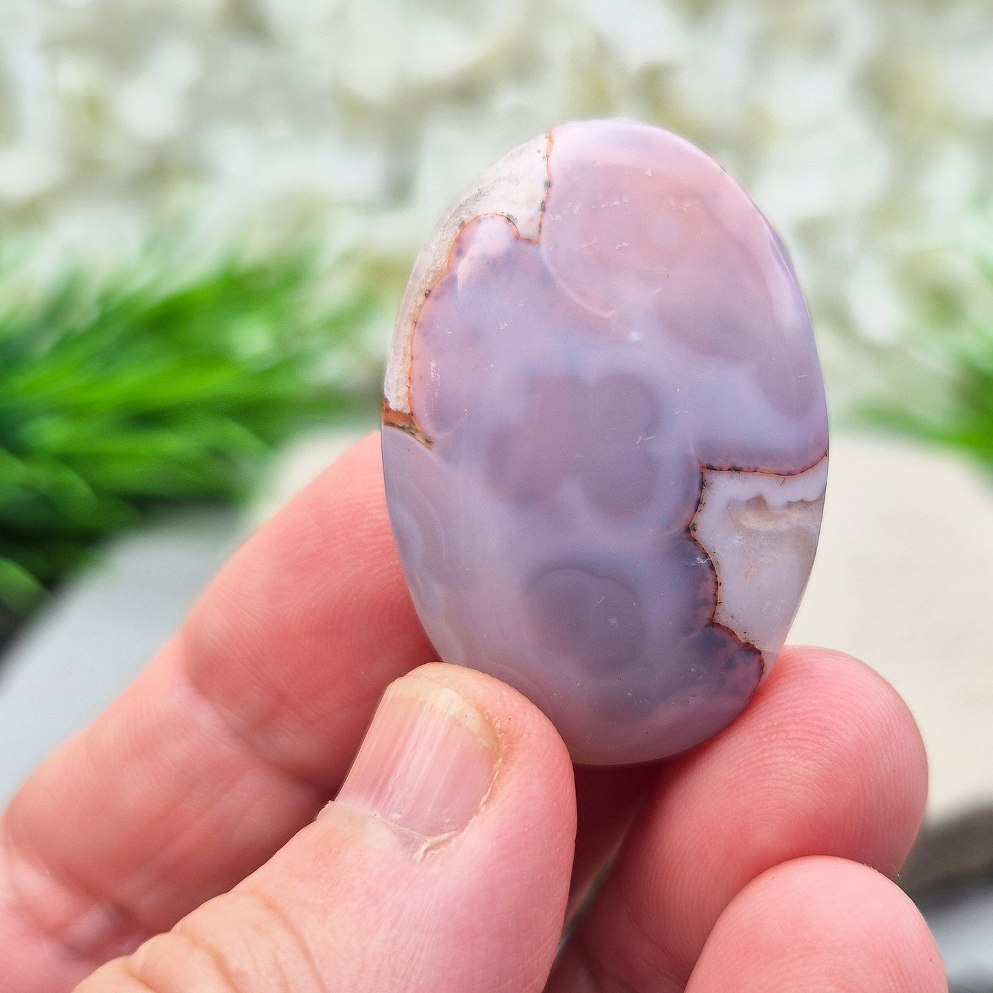This Moroccan Agate palm stone has been polished and shaped to fit comfortably in the hand, making it perfect for daily use.