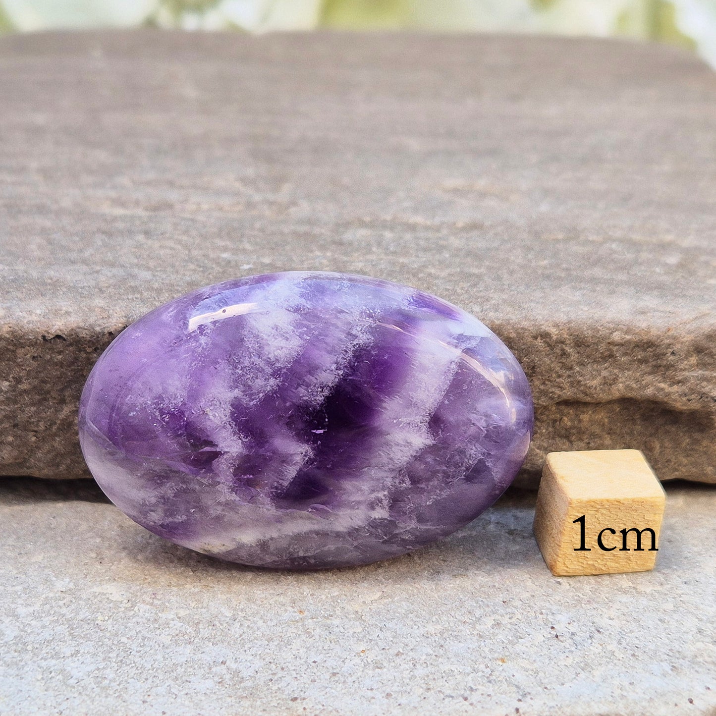 Chevron Amethyst palm stone from Brazil. A soothing crystal that supports clarity, intuition, meditation, and emotional balance.