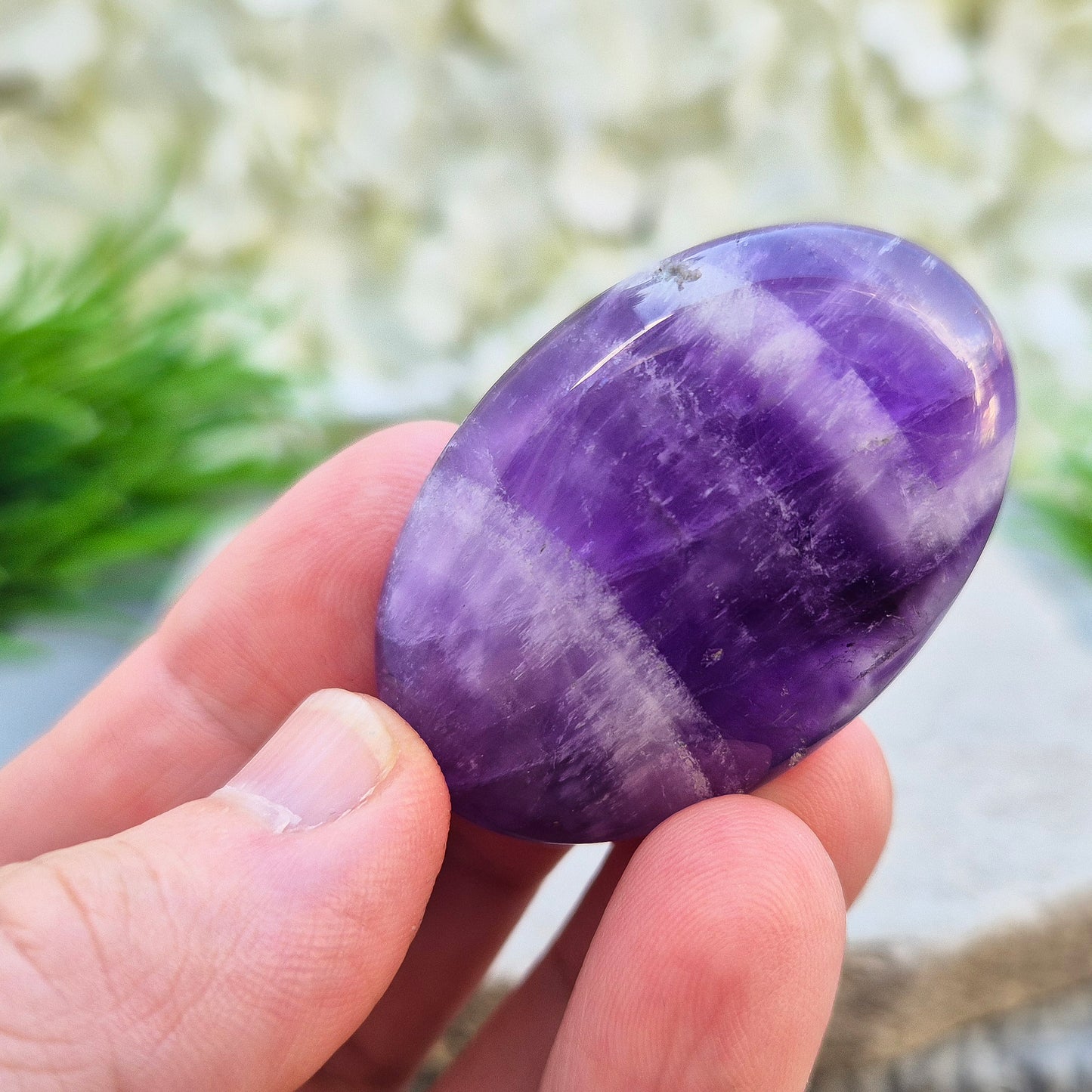 Polished Chevron Amethyst palm stone. Blends Amethyst and Quartz energy for cleansing, calm, courage, and spiritual awareness.