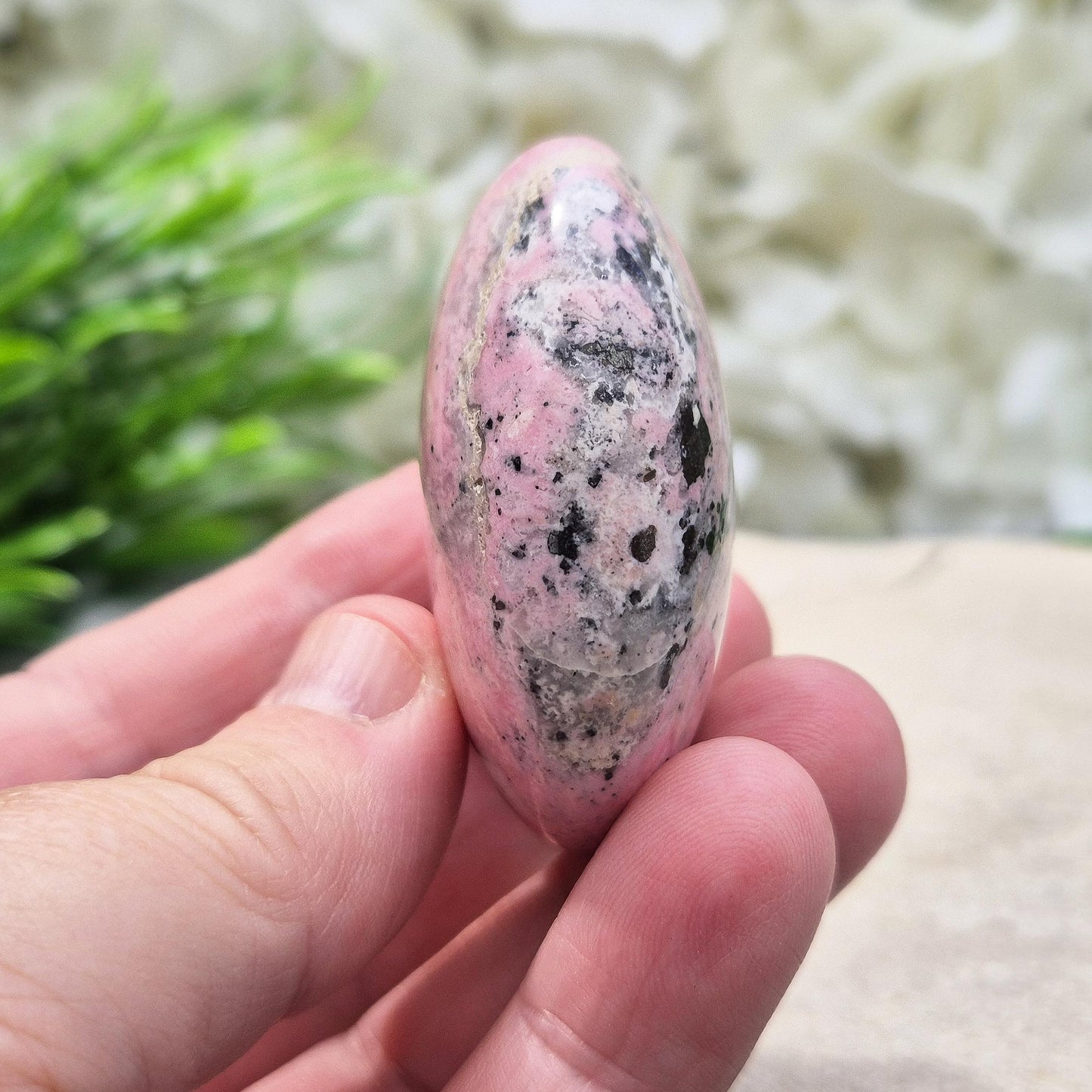 Pink Rhodonite Crystal Palm Stone – Ideal for emotional balance, reflection, and personal growth. Grounding and calming, perfect for meditation or daily use.
