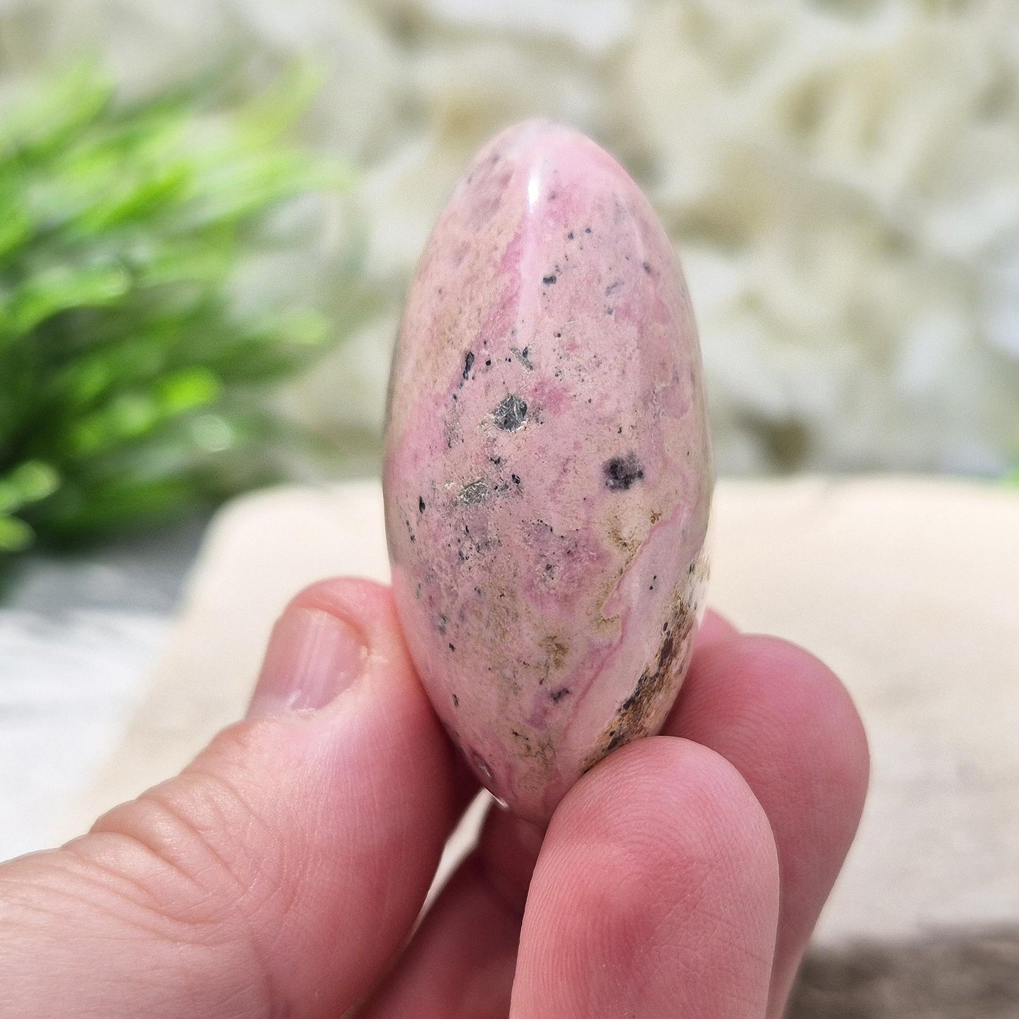 Rhodonite Palm Stone – Polished Bubblegum Pink Crystal from Peru, valued for emotional resilience, reflection, and a grounding, compassionate energy.