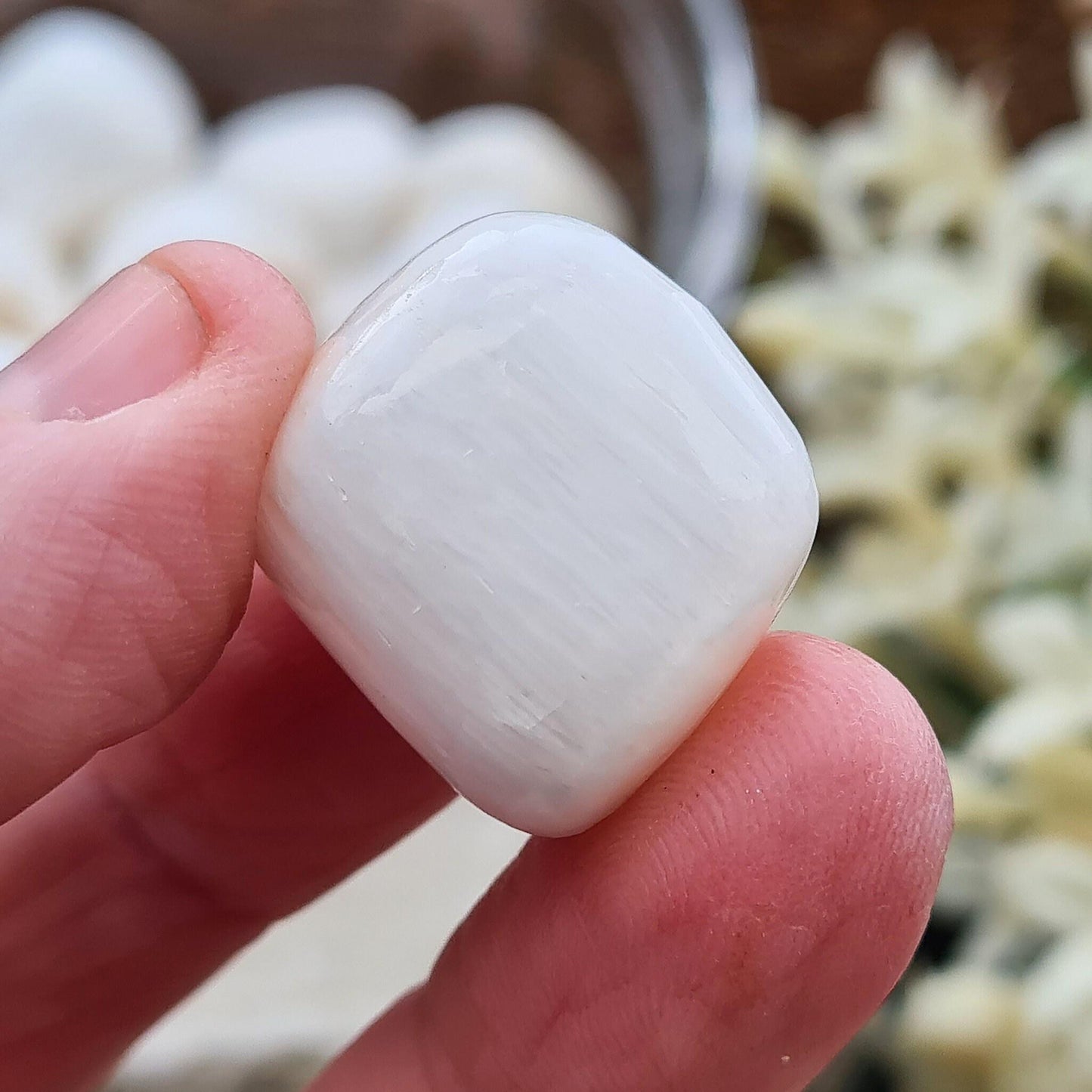 Natural Scolecite tumble stone from Maharashtra, India. Ideal for meditation, winding down, peaceful thinking, and quiet moments of rest.