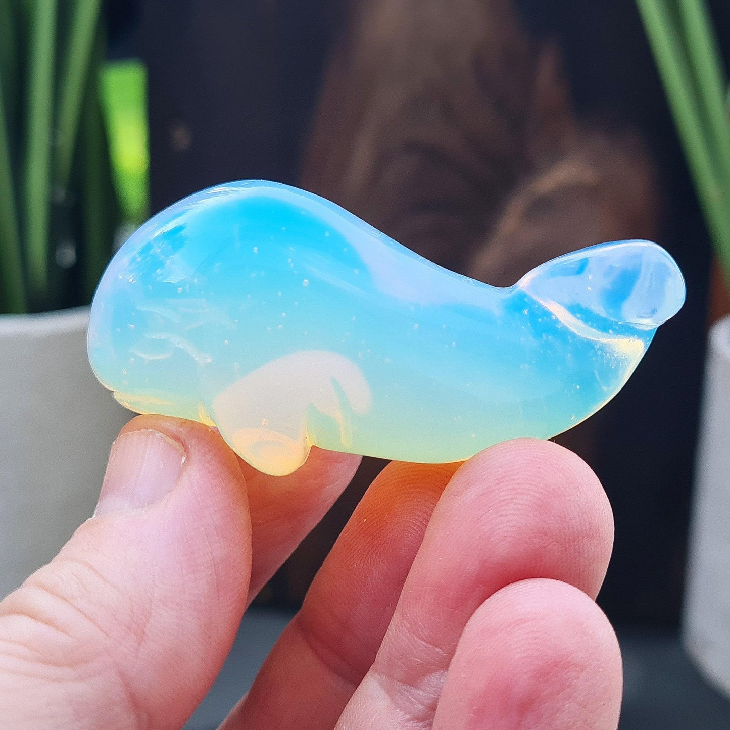Opalite whale crystal carving with soft glow. A calming ocean-inspired figurine for change, communication and emotional balance.