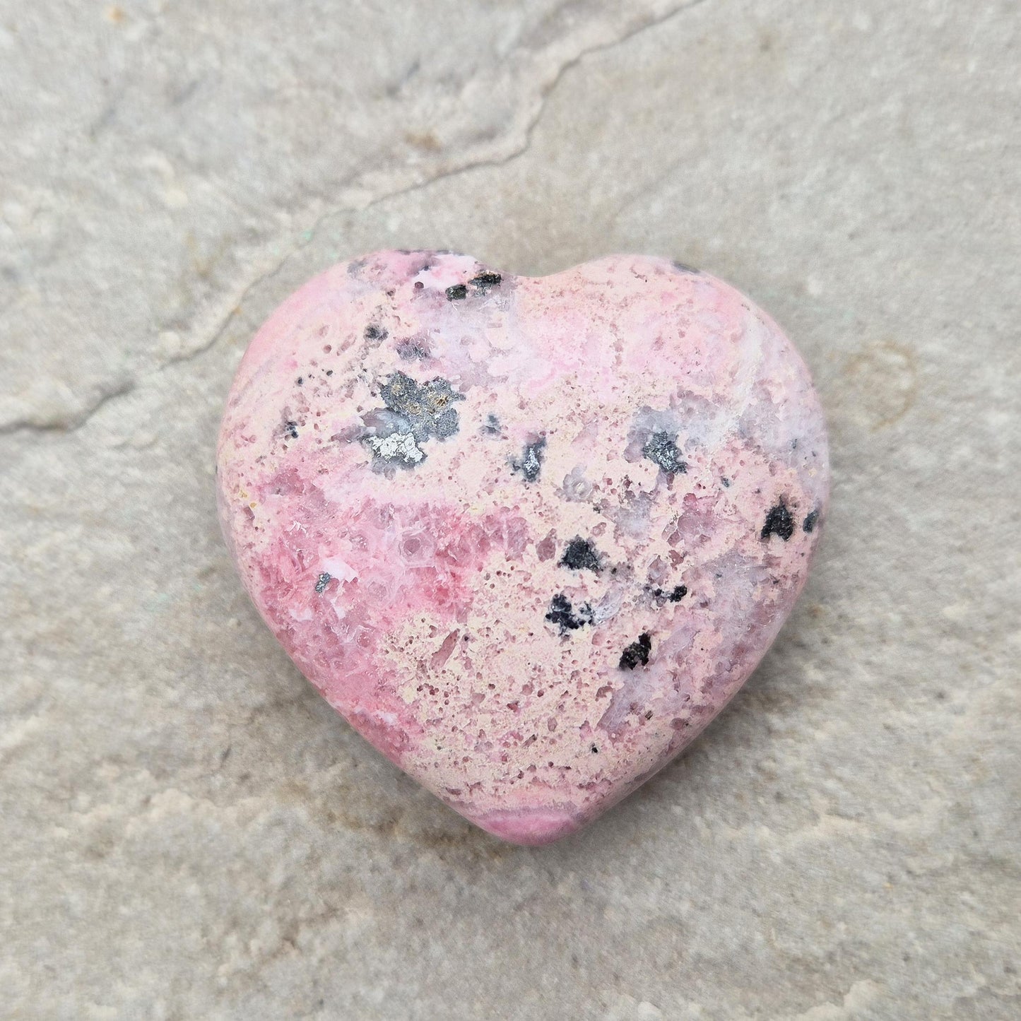 Pink Rhodonite Heart – Encourages love, forgiveness, and emotional balance while supporting personal growth, compassion, and healing.