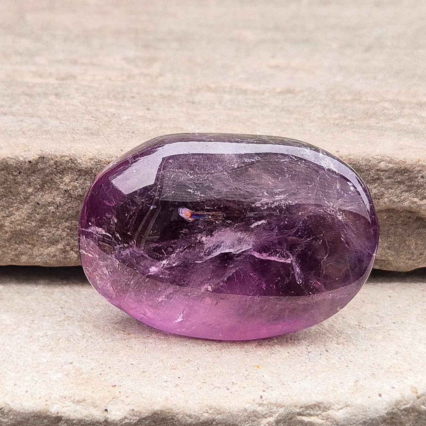 Amethyst Palm Stone with deep purple tones. A soothing crystal for balance, peaceful energy, and gentle spiritual connection.