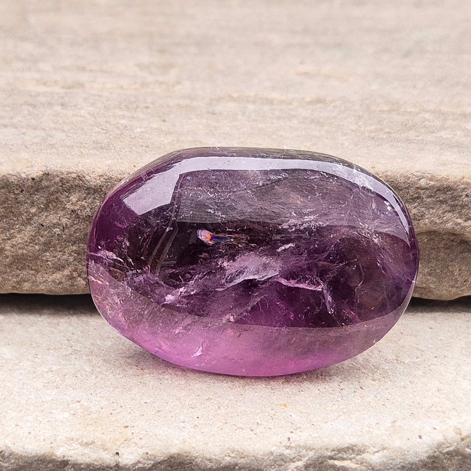 Amethyst Palm Stone with deep purple tones. A soothing crystal for balance, peaceful energy, and gentle spiritual connection.