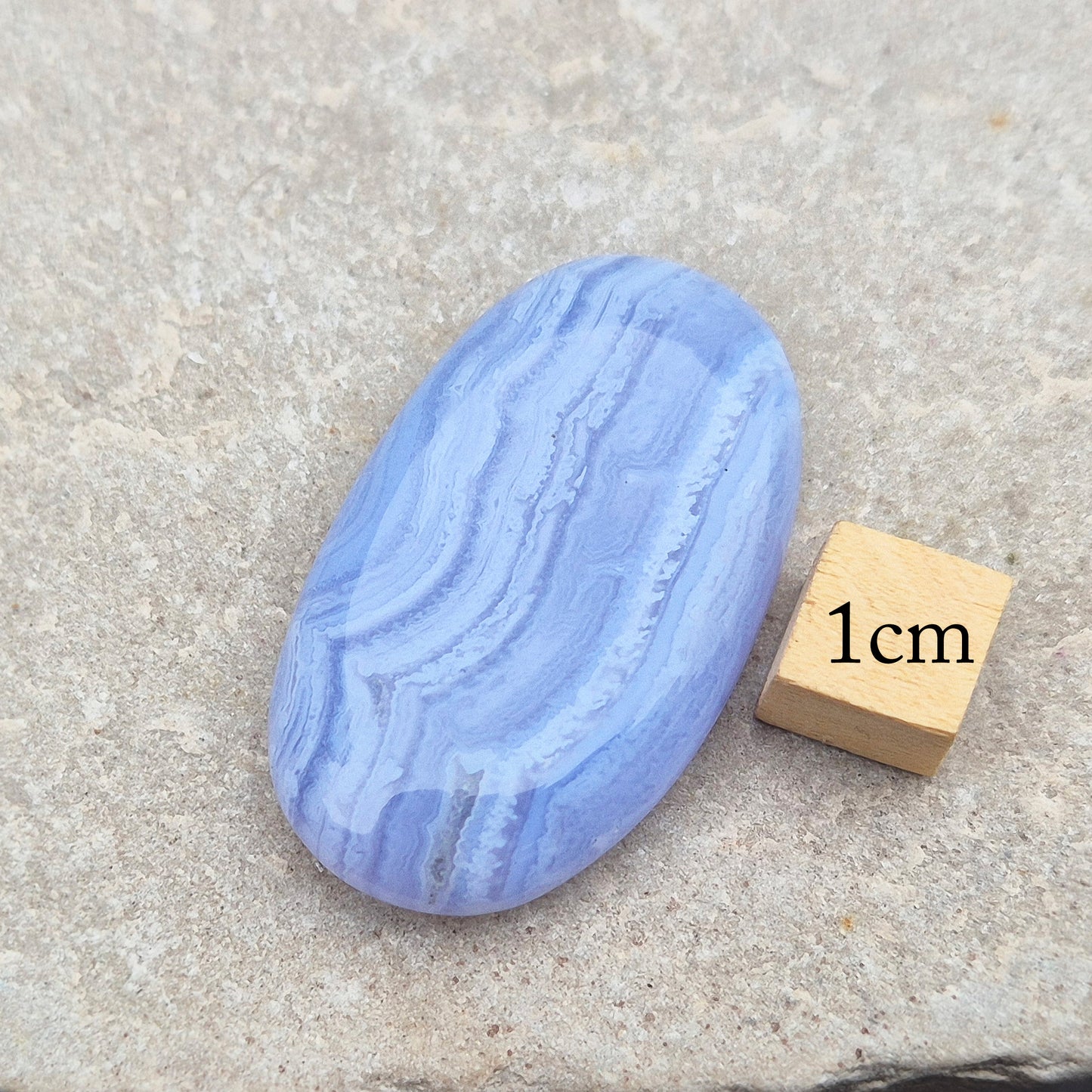 Polished Blue Lace Agate crystal palm stone with wonderful banding. A calming crystal, ideal for relaxation, clear communication and gentle healing.