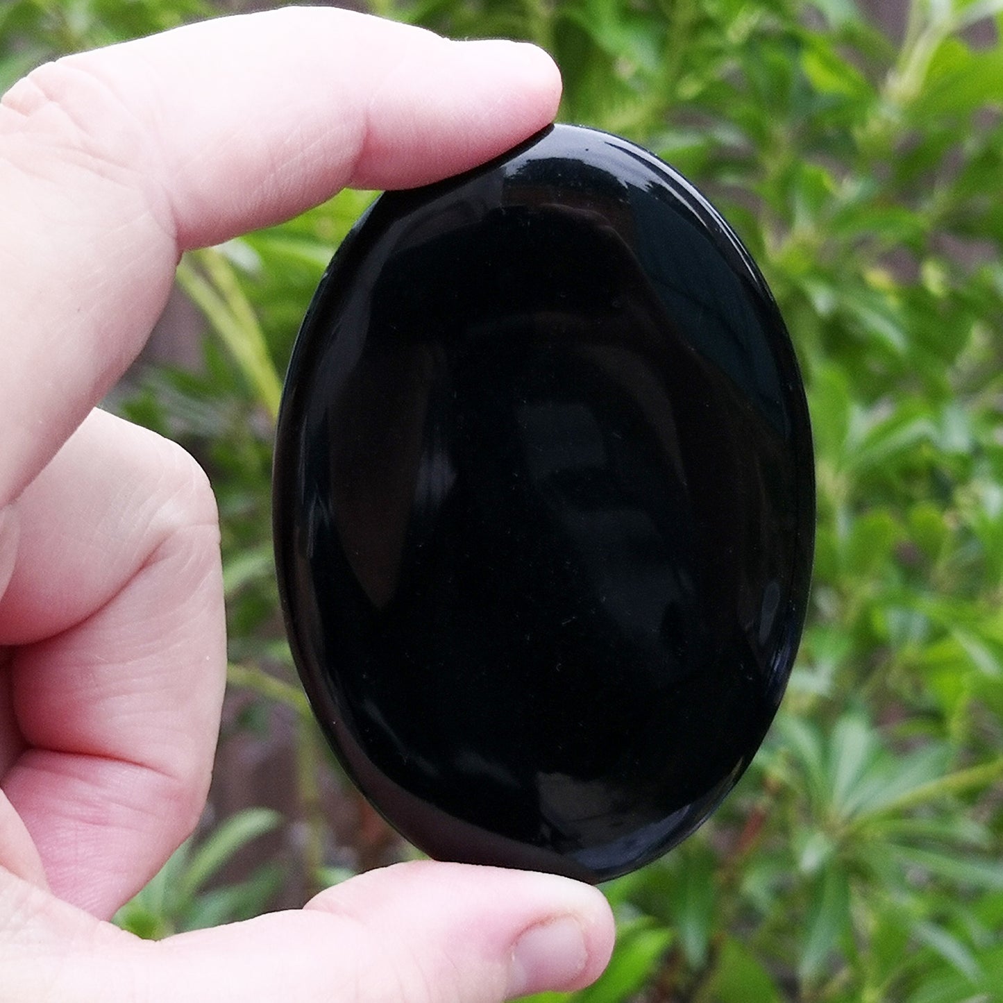 Smooth Black Obsidian palm stone from Mexico. Traditionally associated with grounding, protection, and self-reflection. Ideal for everyday support.