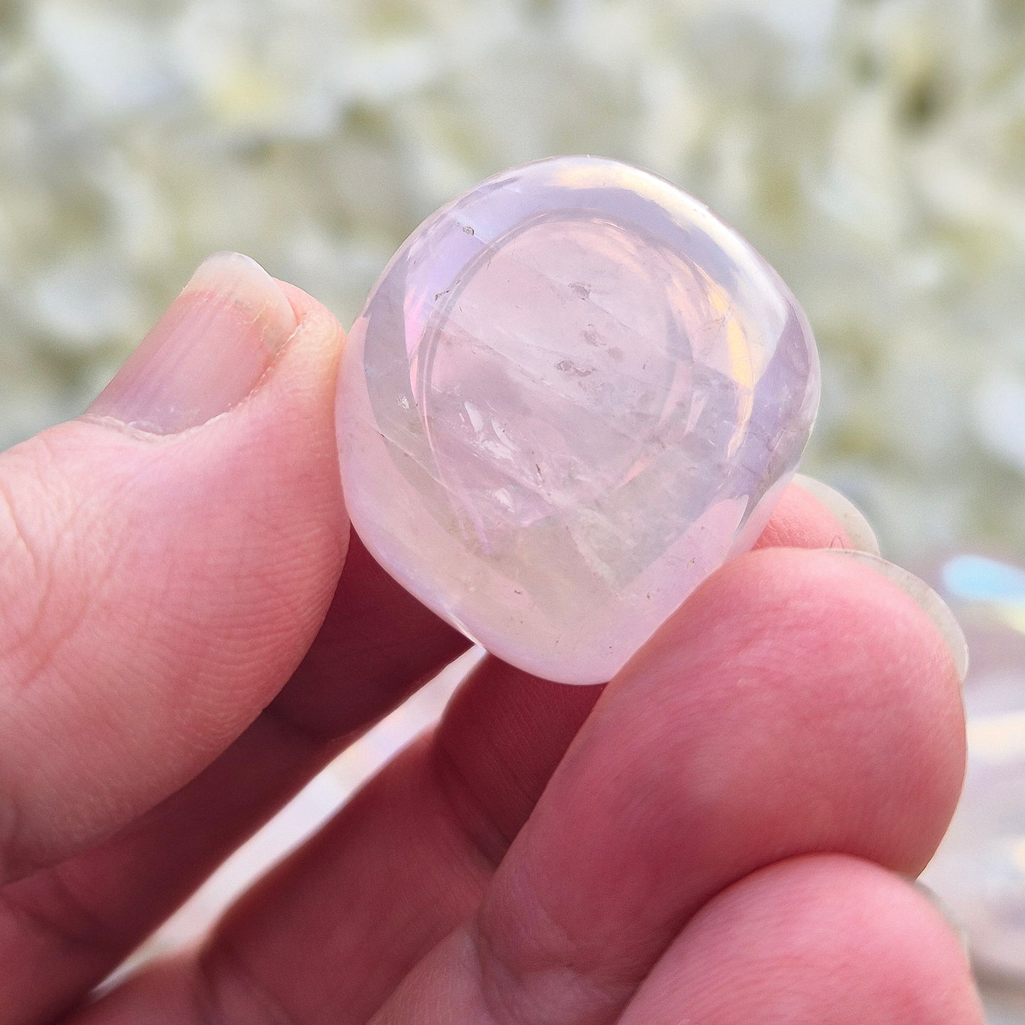 Rose Quartz Aura tumblestones, polished pink crystals with iridescent sheen. Heart chakra stones for emotional support and meaningful crystal gifts.