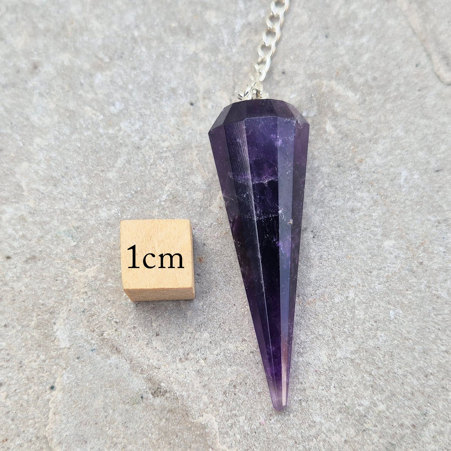 Dark Amethyst crystal pendulum for dowsing and spiritual guidance. A striking divination tool chosen for intuition, pendulum readings, and energy balancing.