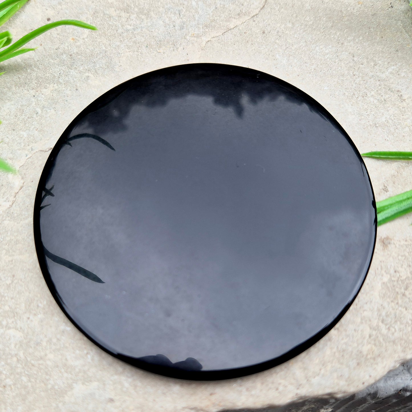 Natural Black Obsidian scrying mirror for divination, meditation, and spiritual work. A polished volcanic glass used for grounding and reflection.