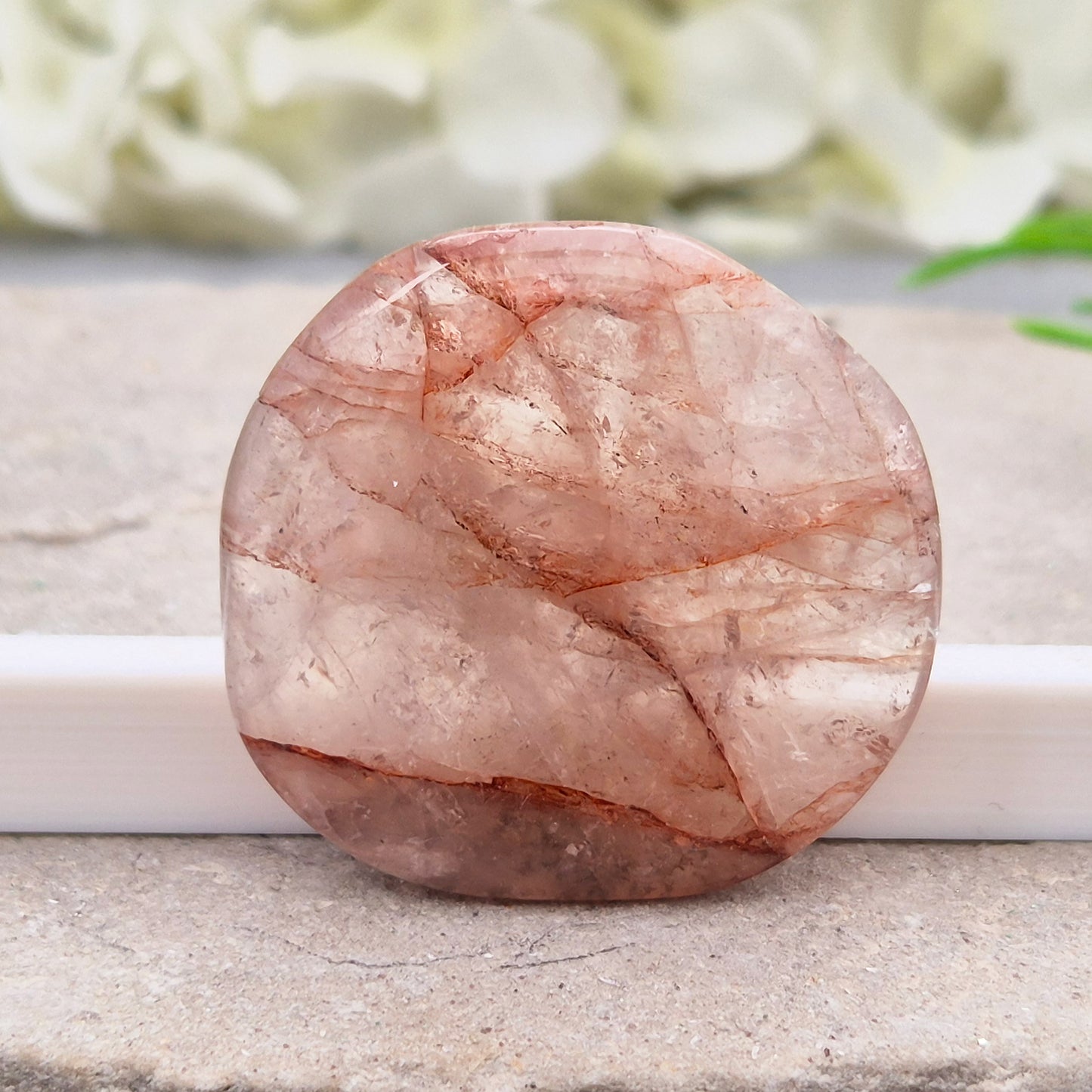 Shop this natural Crimson Healer Palm Stone with beautiful rainbows and Hematite inclusions. A grounding crystal for confidence, focus and balance.