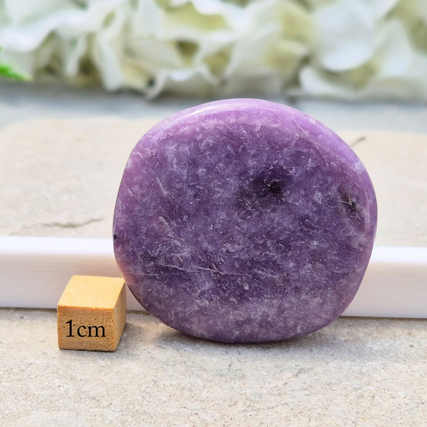 Lepidolite palm stone with calming, balancing energy. Known for easing stress and emotional overwhelm. Smooth, soothing, and ideal for daily support.