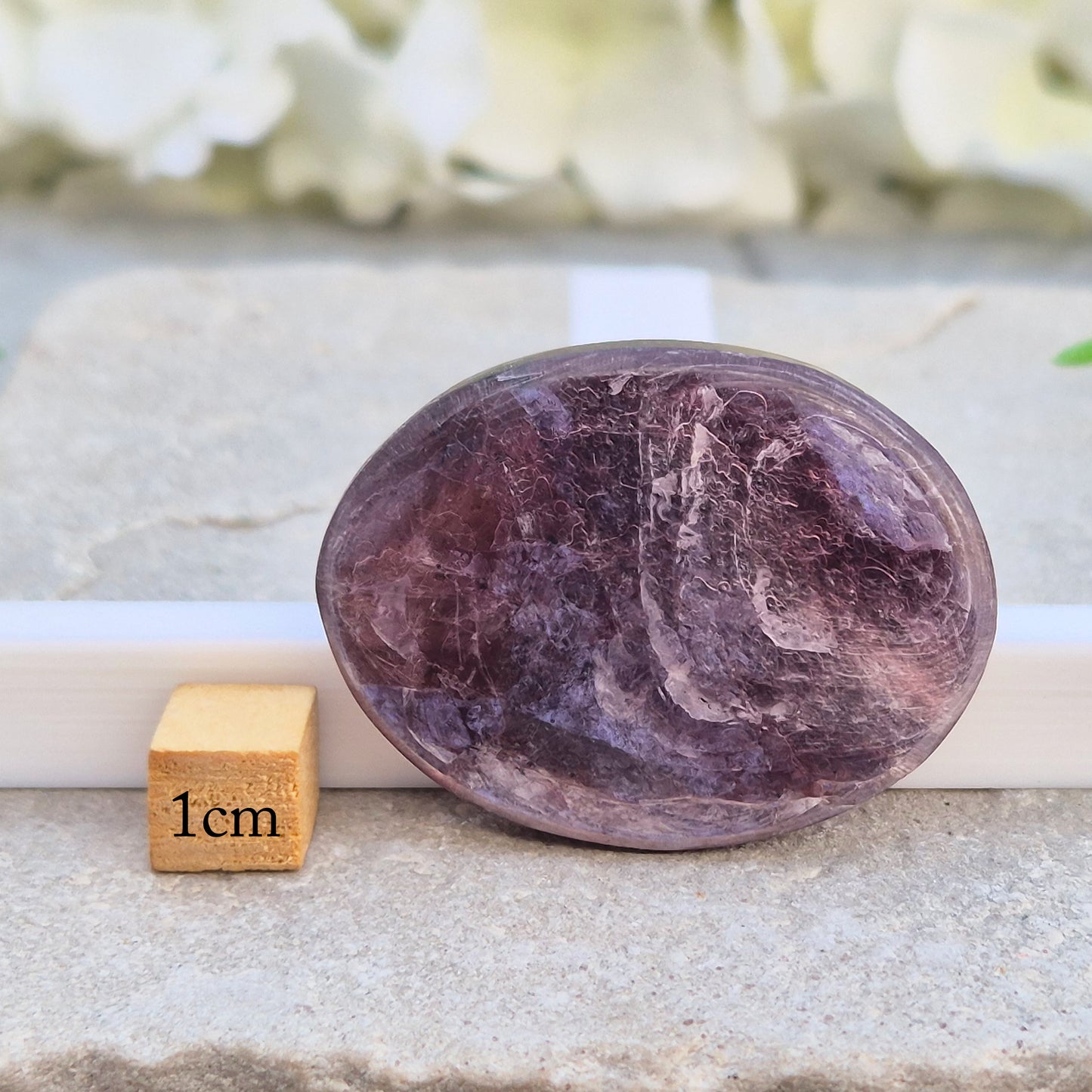 Metallic lilac Mica palm stone. Smooth, reflective, and grounding. Supports focus, calm emotions, and adds uplifting energy to any space.