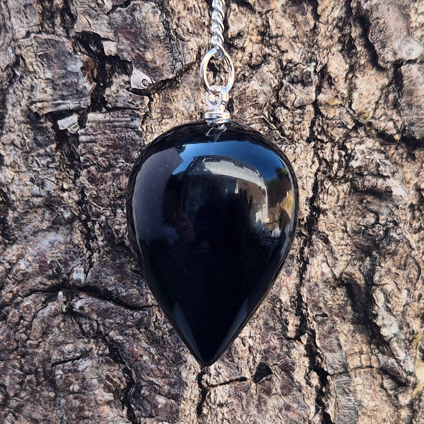 Black Obsidian teardrop pendulum for dowsing & energy work. Grounding and protective, this natural crystal helps clear negativity and ground your energy.