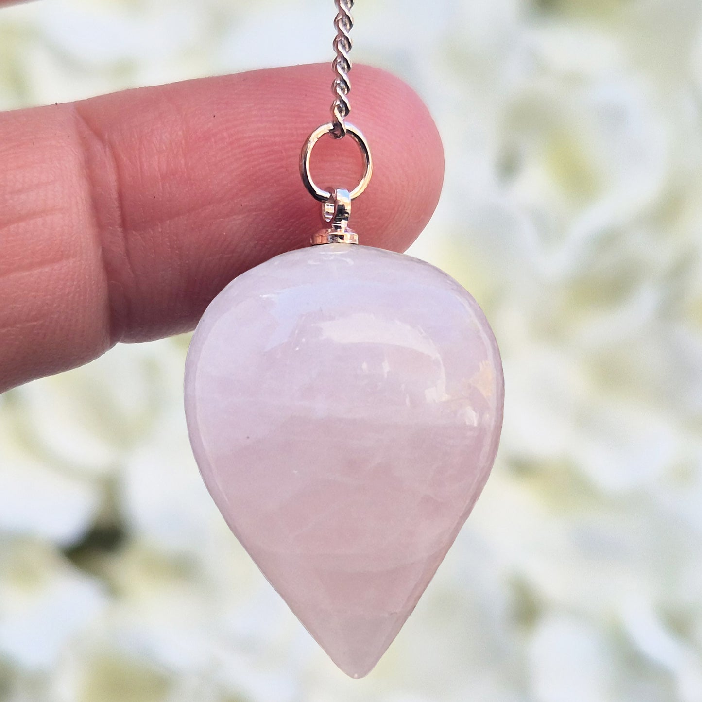 Rose Quartz Crystal Pendulum with a tear drop shape and its has a pale pink bead at the end of the chain. It will come with an organza pouch for safe keeping.