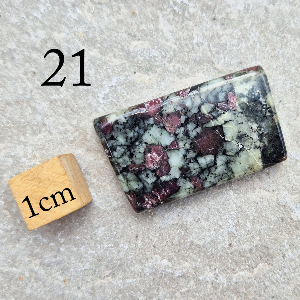 Hand-picked polished eudialyte slice with raspberry-pink and natural black and grey patterning. Often reached for heart-centred meditation.